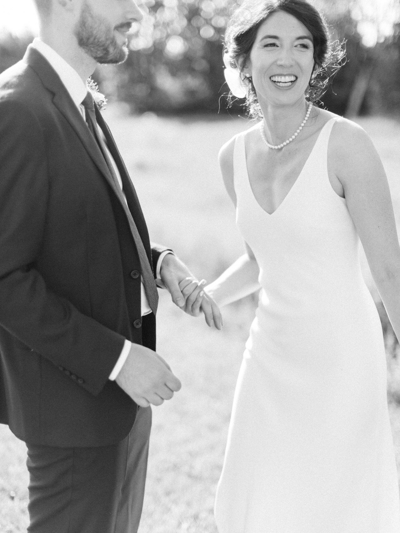 bride and groom posing naturally for their outdoor summer wedding at silver springs retreat