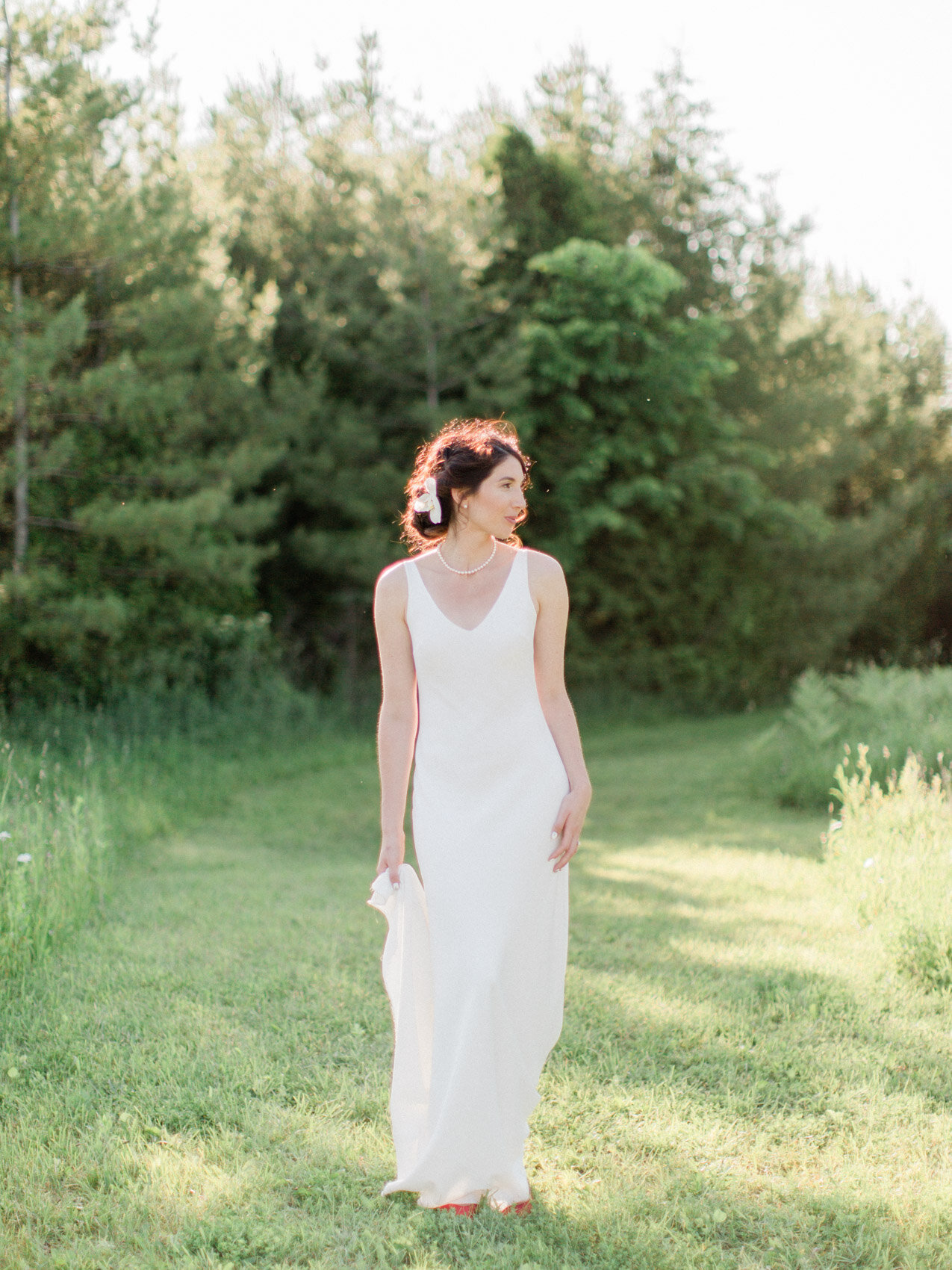 chic bridal style in a simple slip dress with an orchid in her hair.