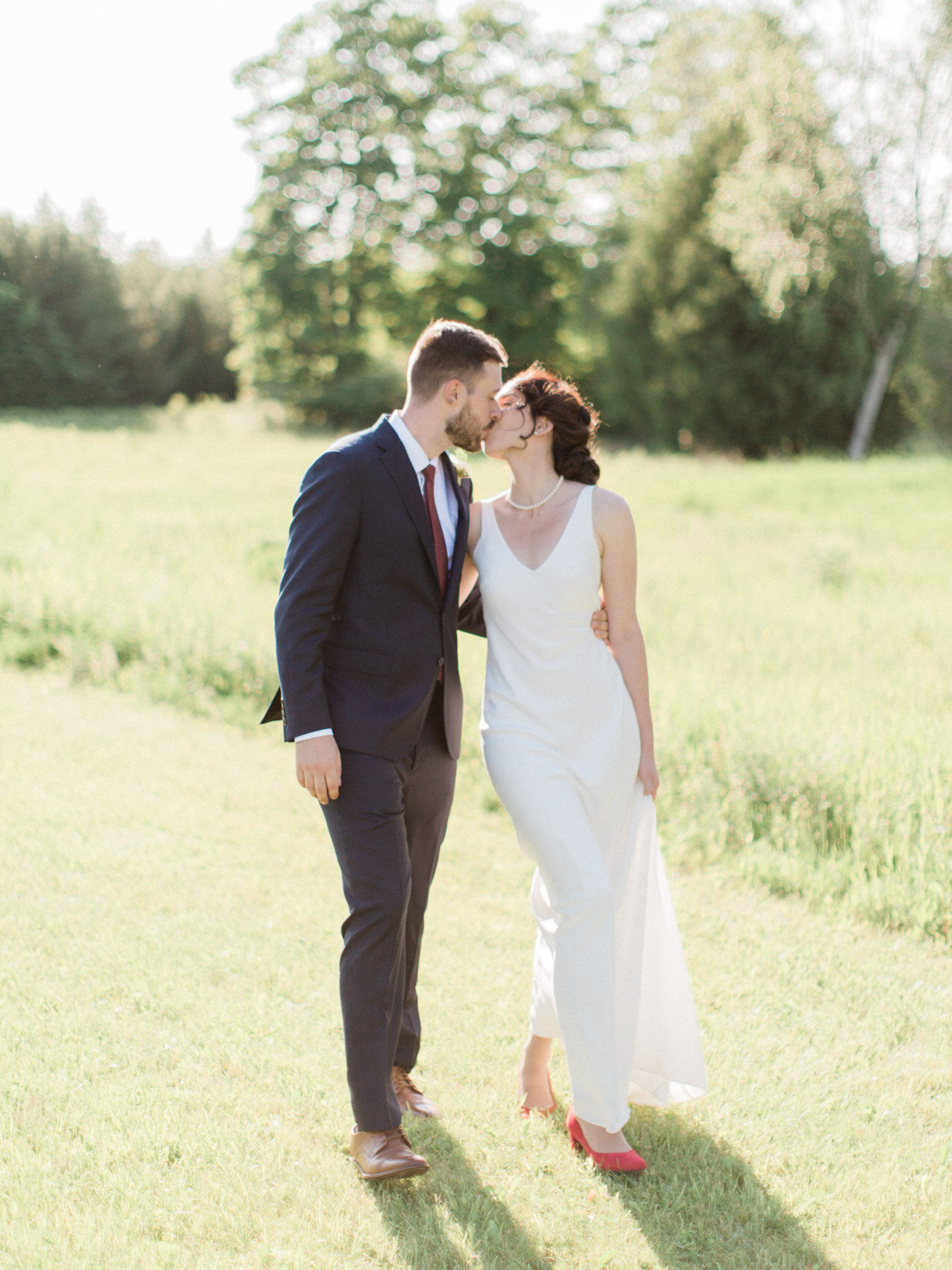 bride and groom posing naturally for their outdoor summer wedding at silver springs retreat