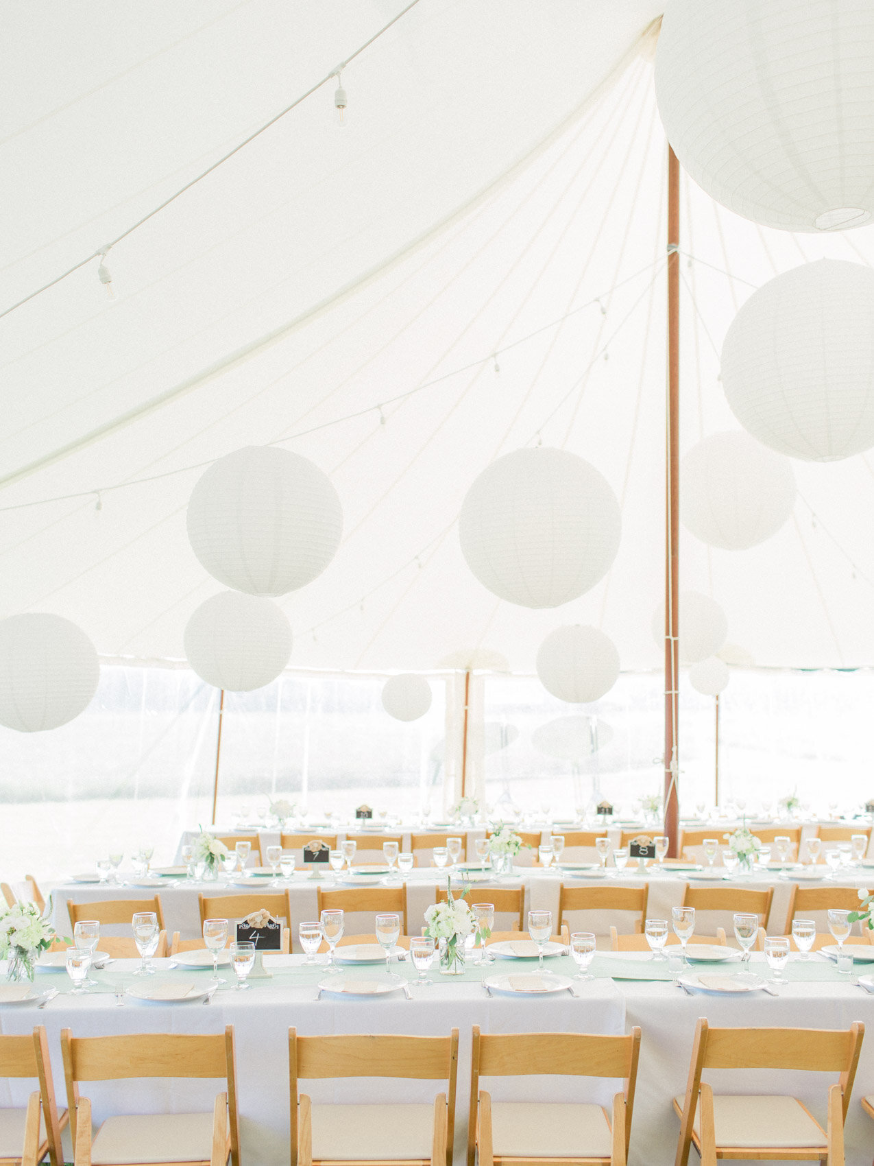 beautiful circus top tent with floating lanterns at an outdoor summer wedding at silver springs retreat