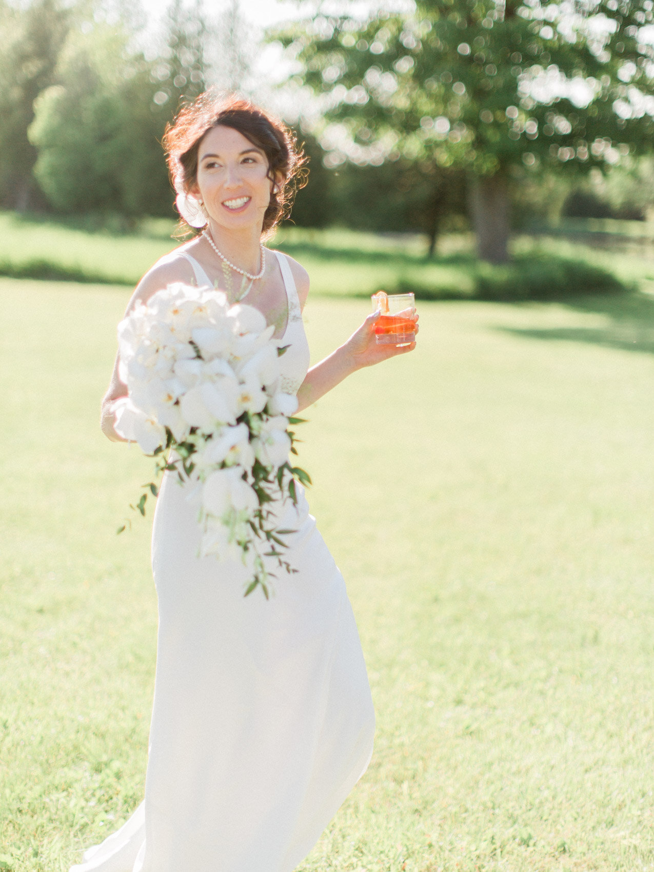 chic bridal style in a simple slip dress with a bouquet of white orchids