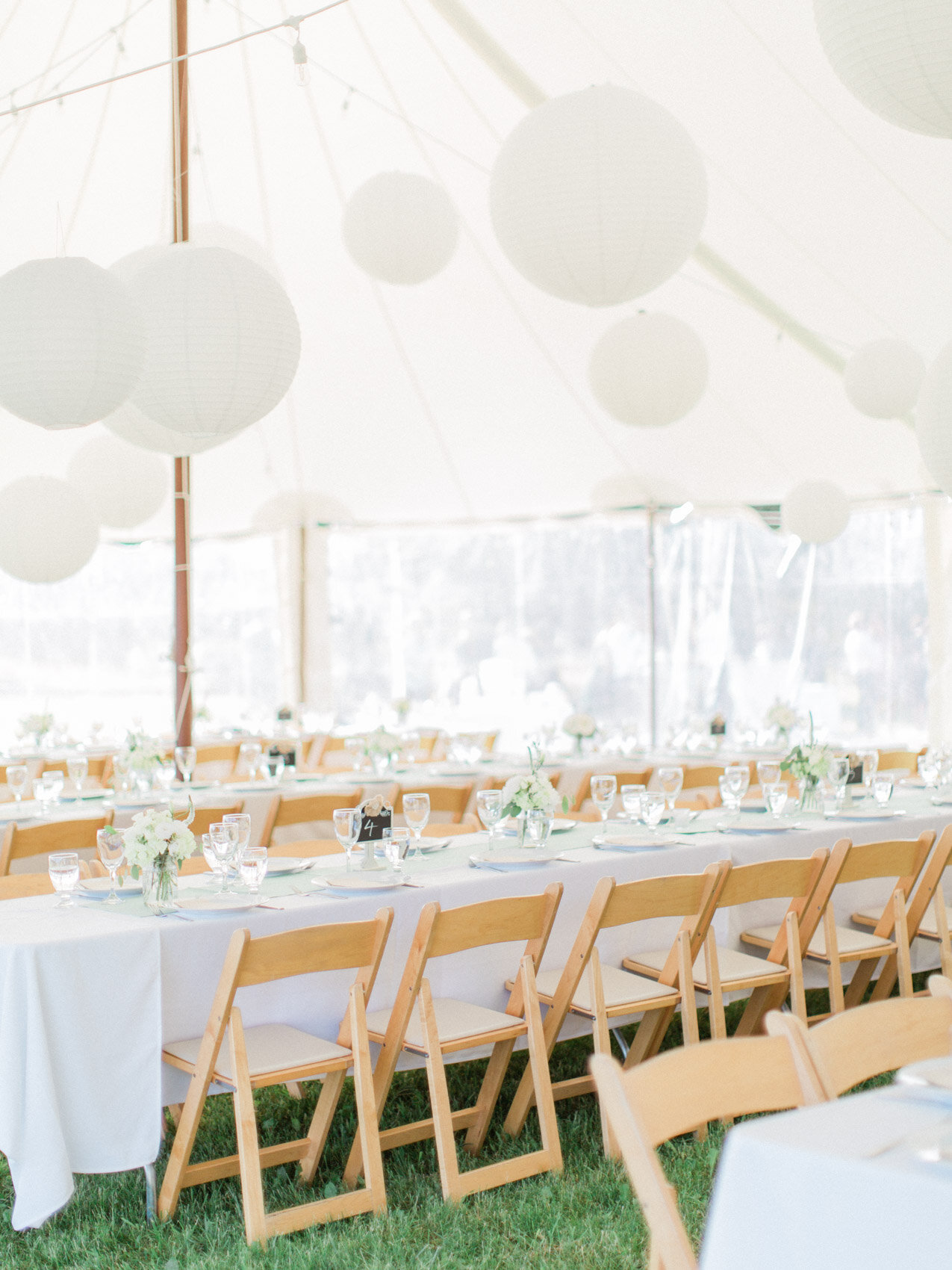beautiful circus top tent with floating lanterns at an outdoor summer wedding at silver springs retreat