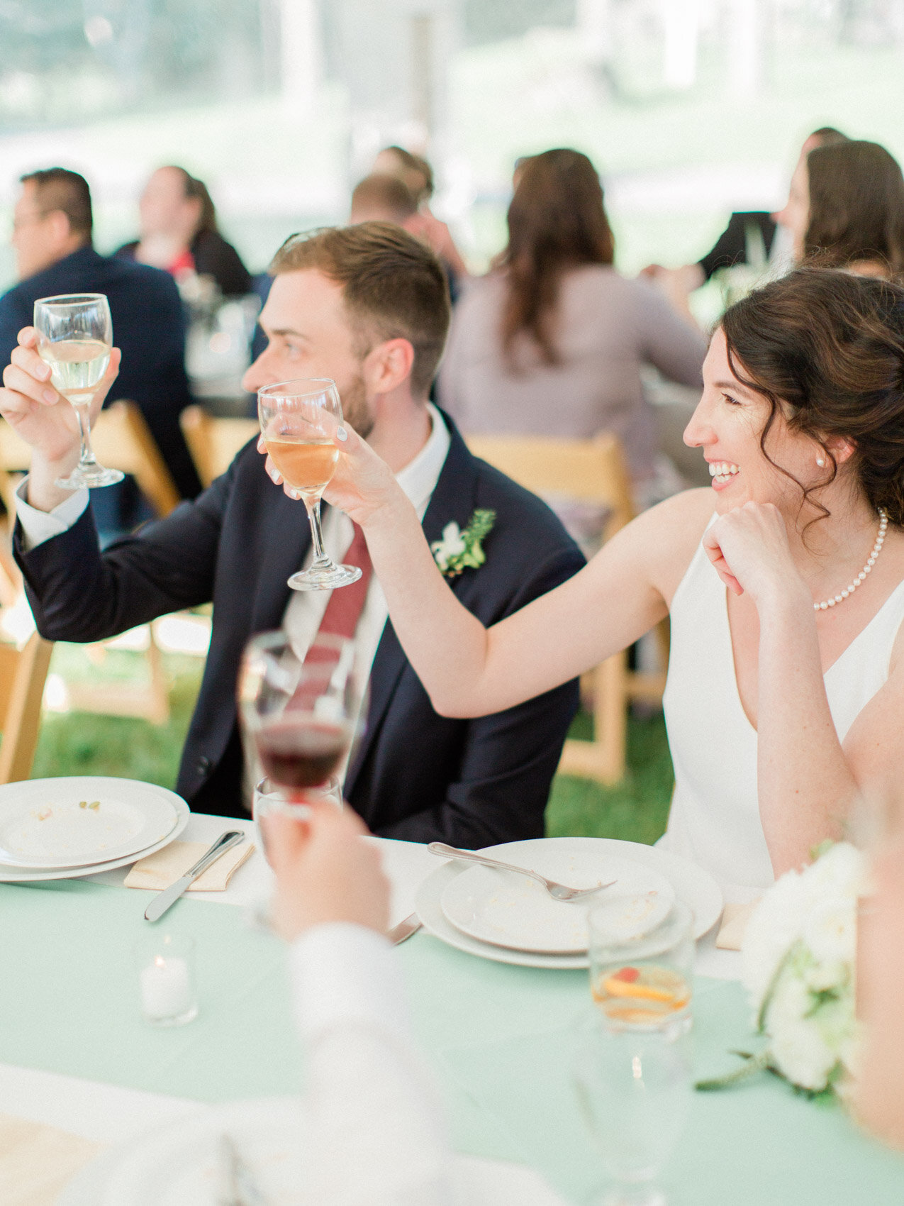 candid cheers at an outdoor summer wedding reception at silver springs retreat