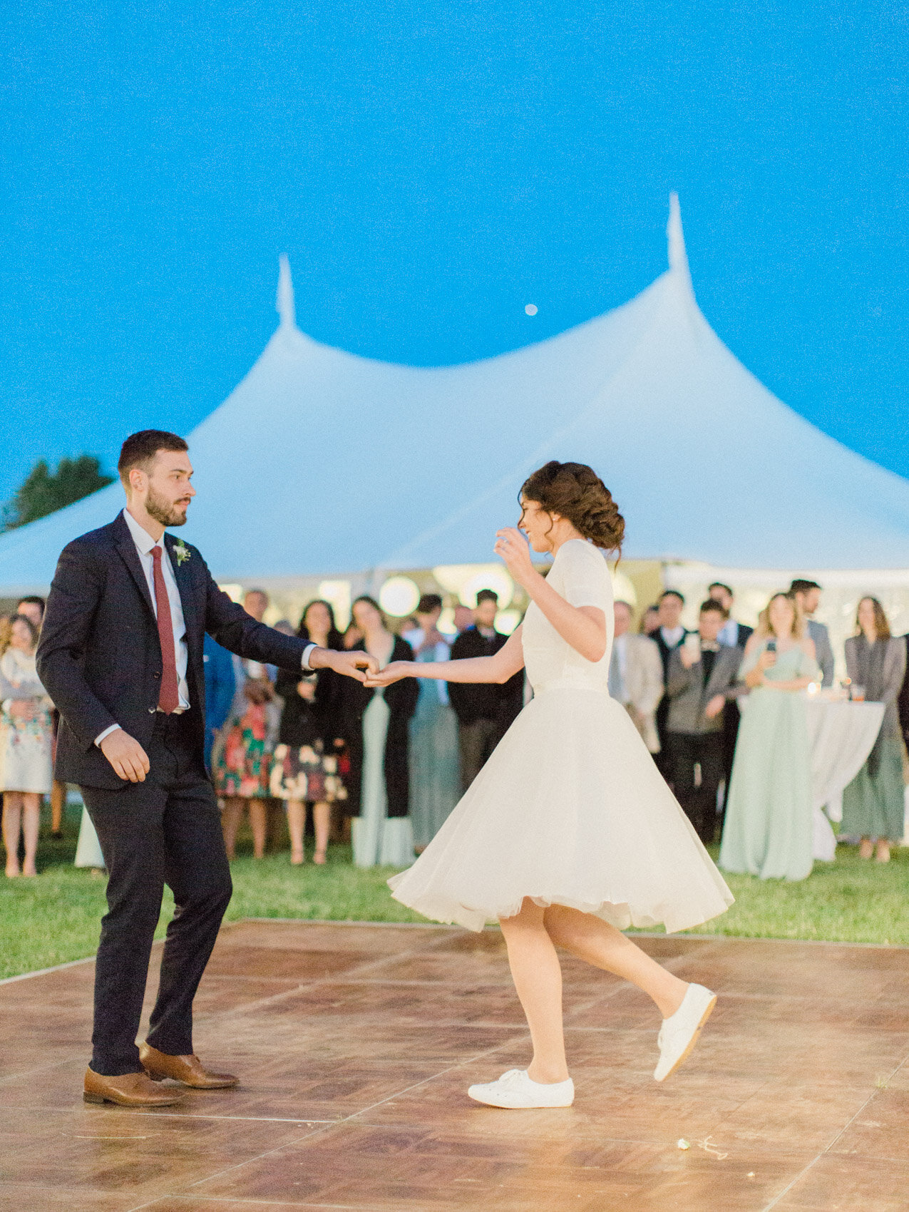 candid first dance photo outdoors under the stars