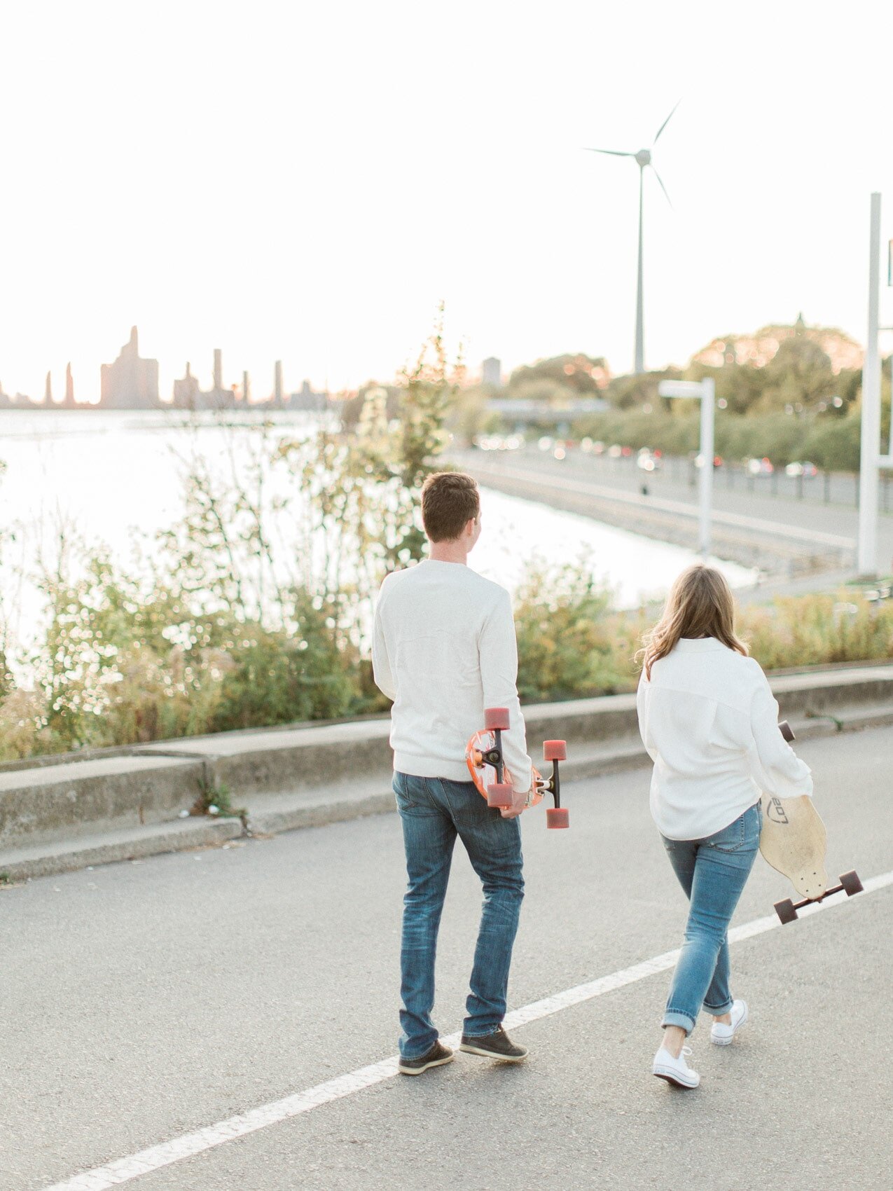 A relaxed couple with their longboards at their engagement session in Toronto