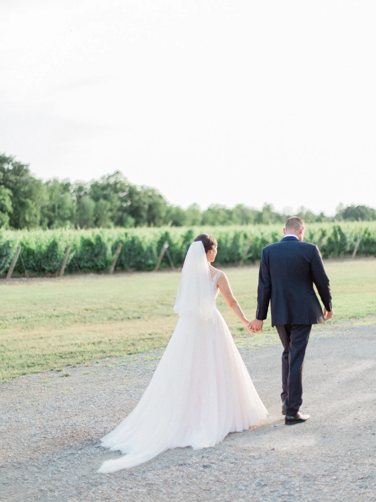 bride and groom posing naturally for wedding photographs at chateau des charmes niagara