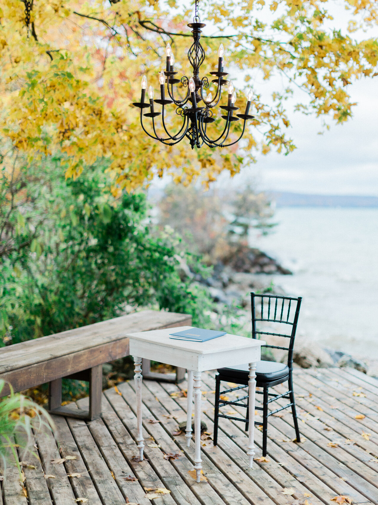 a signing table with a chandelier at a small outdoor fall wedding