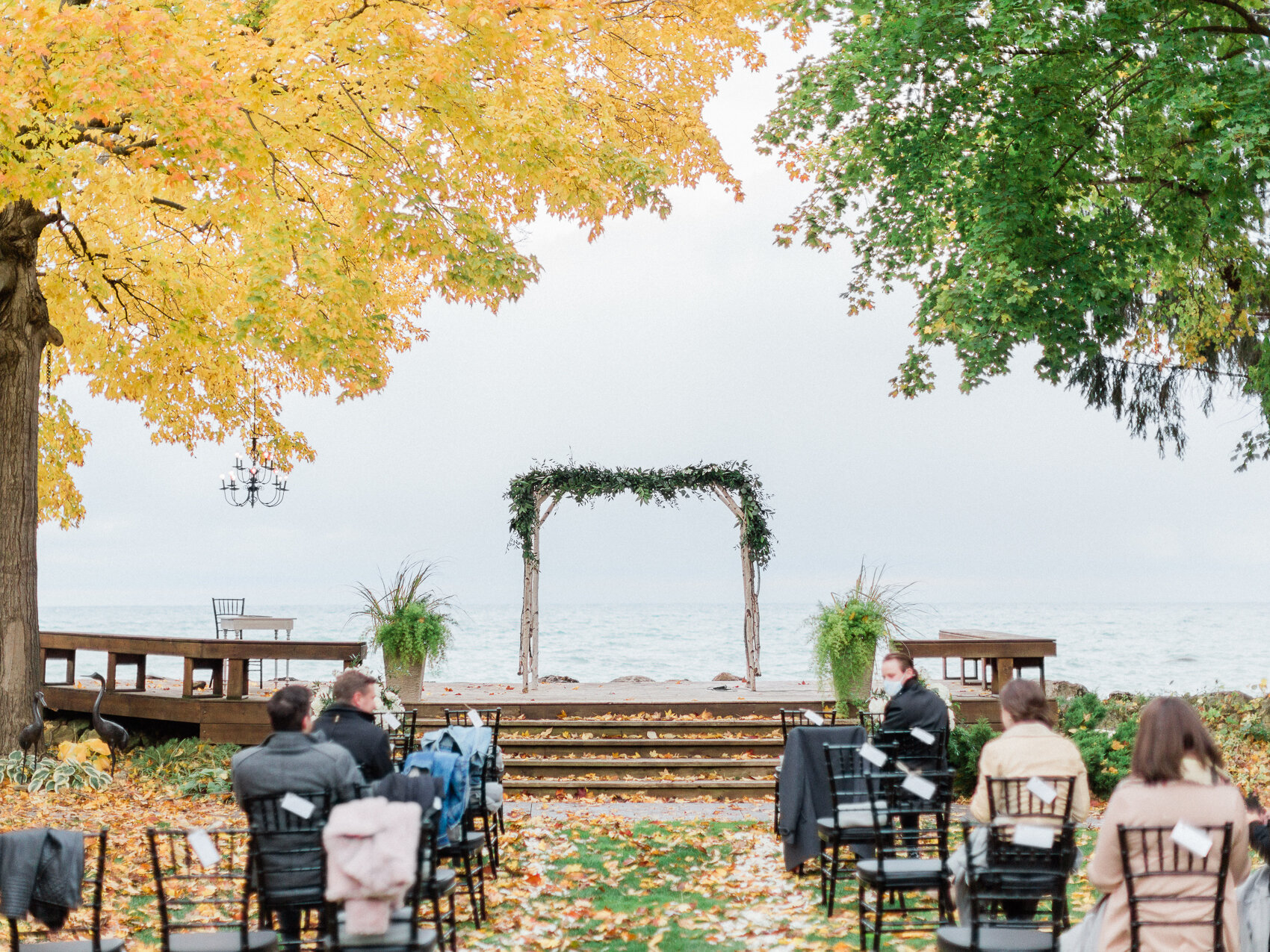 An outdoor ceremony setting for a fall wedding at a backyard wedding