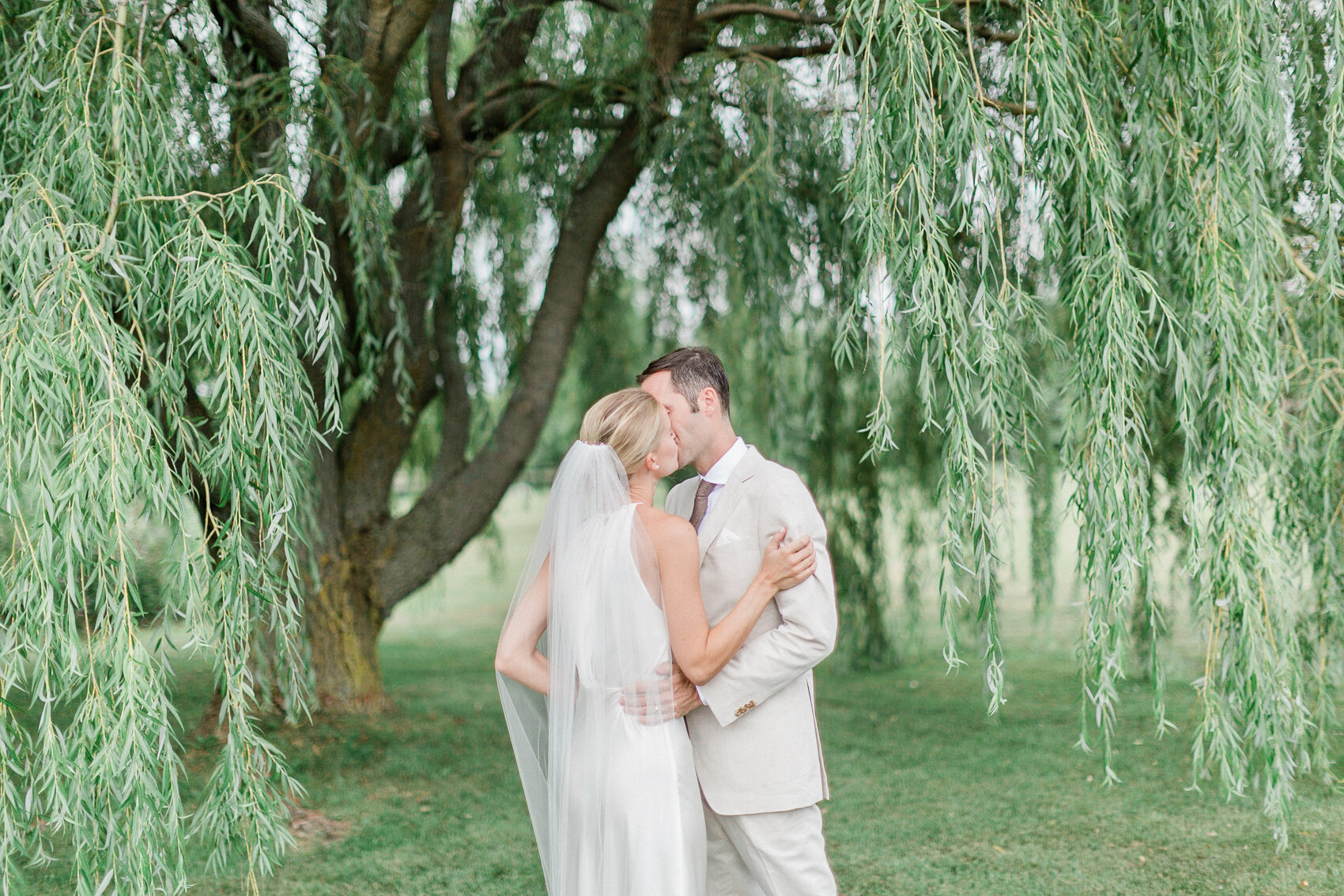 a couple have their first kiss at their backyard georgian bay elopement