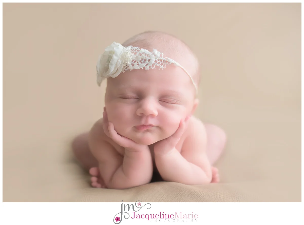 Columbus Ohio Newborn Photographer poses baby girl on tan backdrop with image featuring baby toes