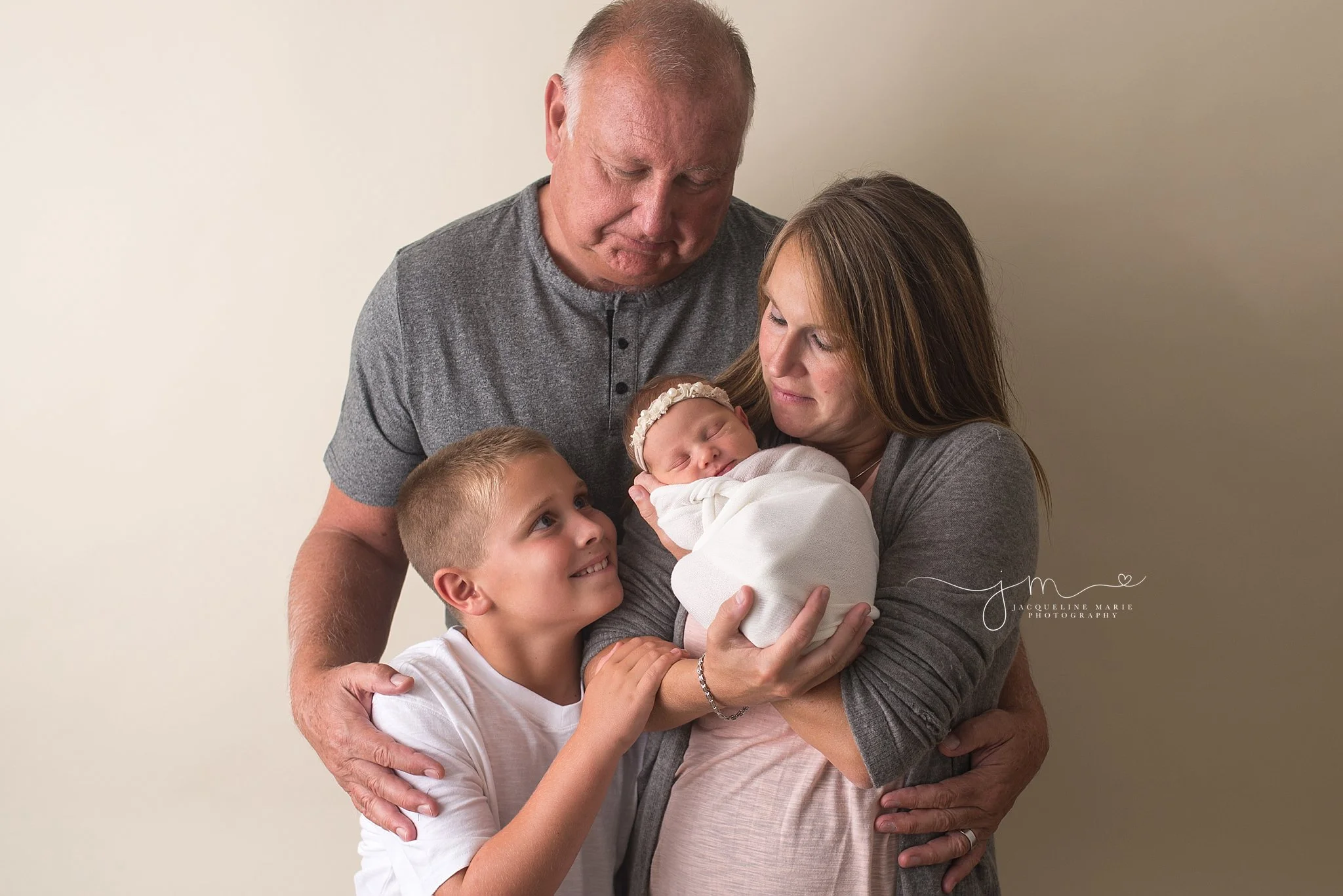 Jacqueline Marie Photography newborn portrait features family holding newborn baby in Columbus Ohio