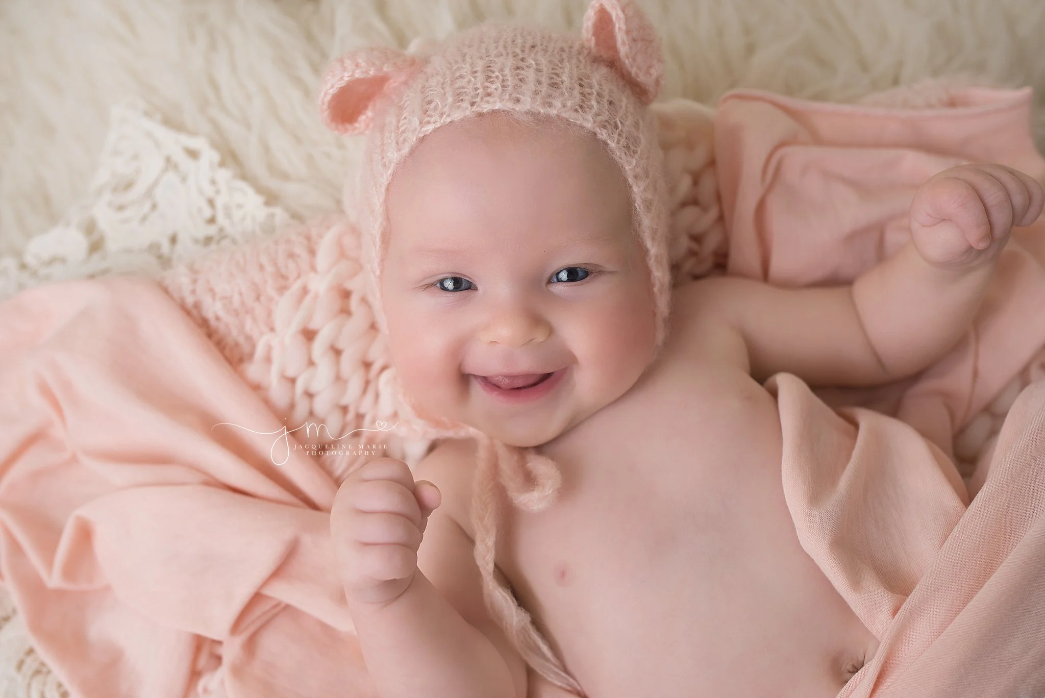 3 month old baby girl wears pink bear bonnet for portrait session at Jacqueline Marie Photography in Columbus Ohio