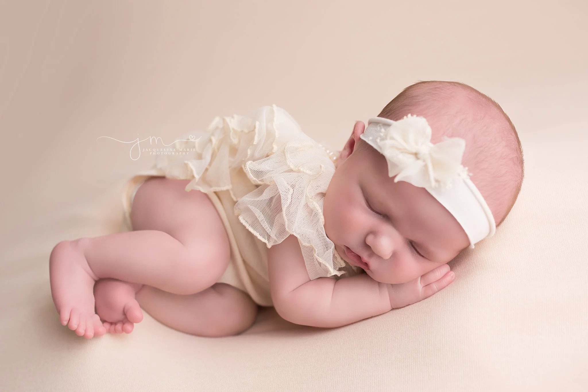 Sleeping newborn baby girl portrait features fingers and toes while baby sleeps in Columbus Ohio at Jacqueline Marie Photography