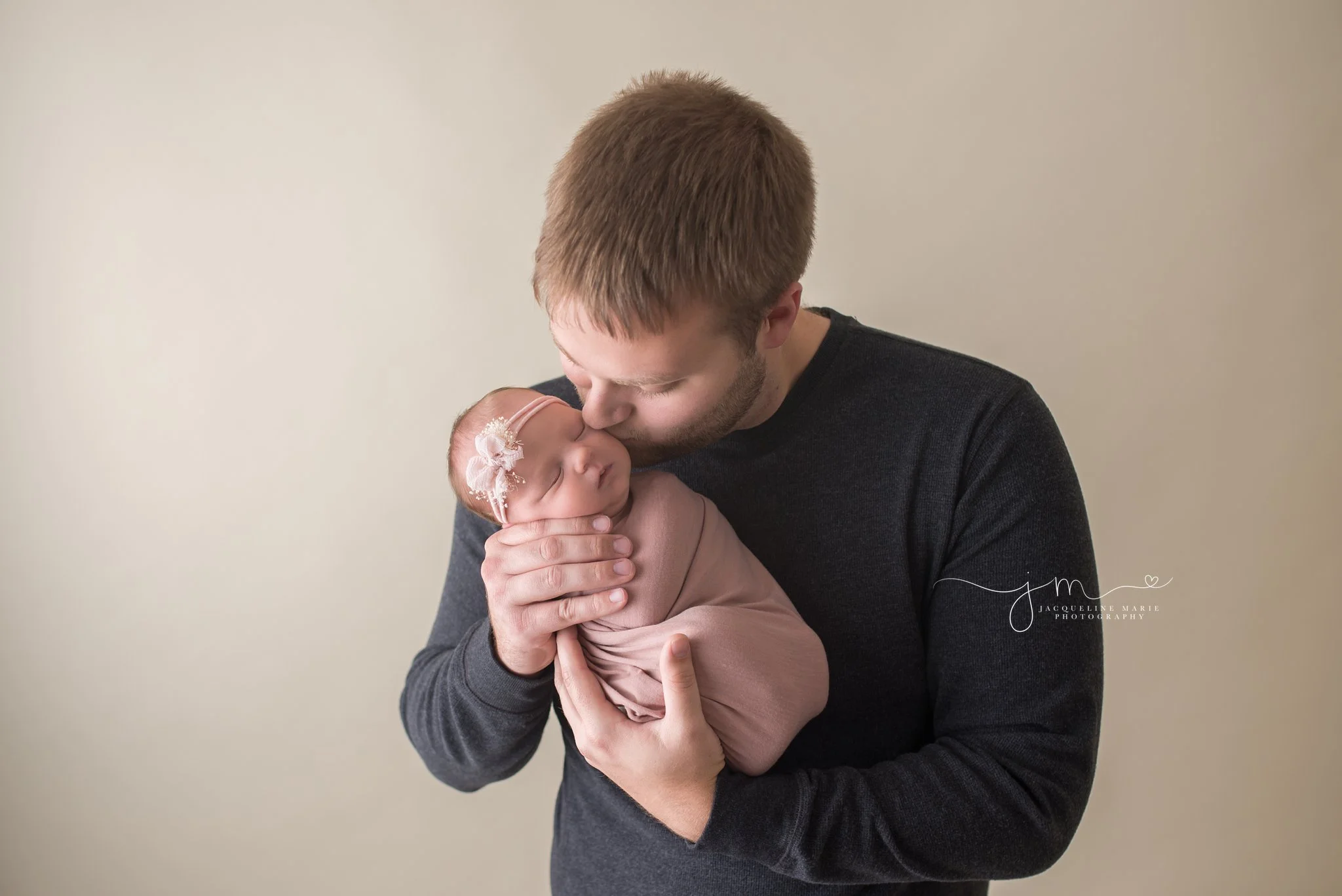 12 day old newborn baby girl is held by father for newborn photography session in Columbus Ohio