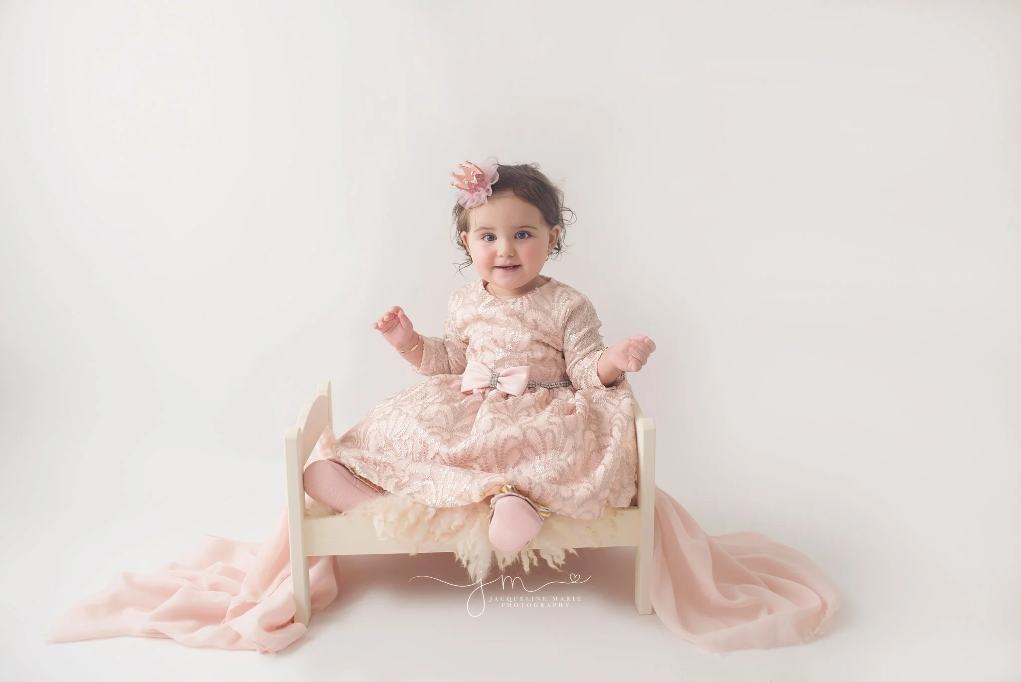 One year old little girl wears pink and silver dress for first birthday pictures in columbus ohio