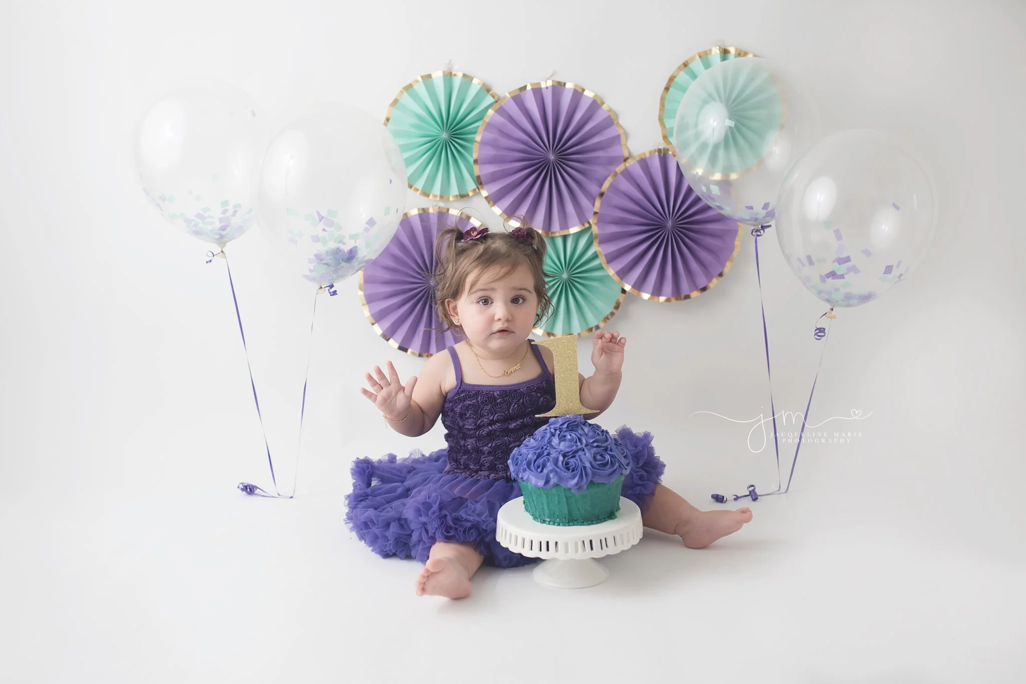 first birthday cake smash pictures features purple and turquoise cake with confetti balloons in columbus ohio