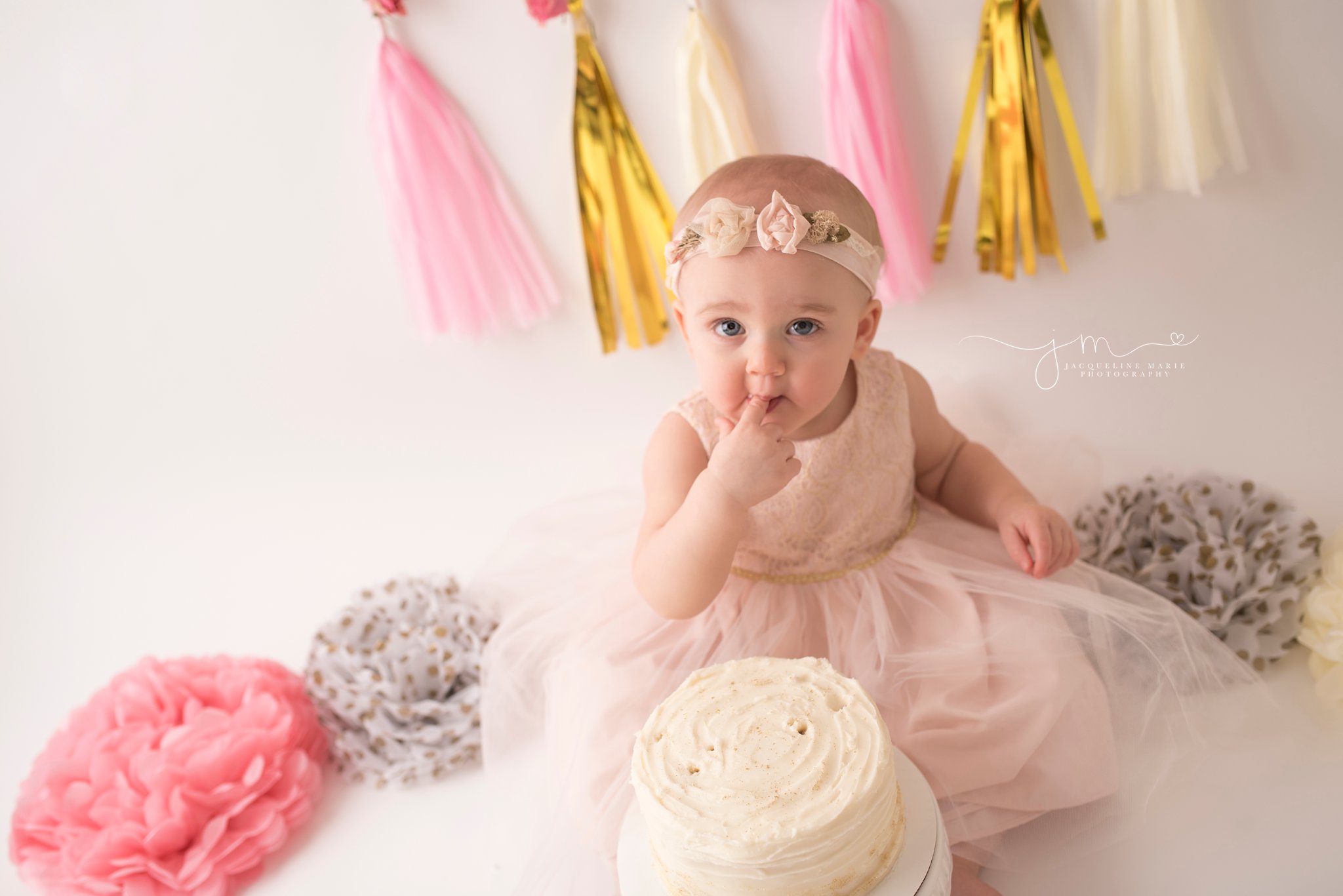 one year old baby girl celebrates first birthday with cake smash photography in columbus ohio