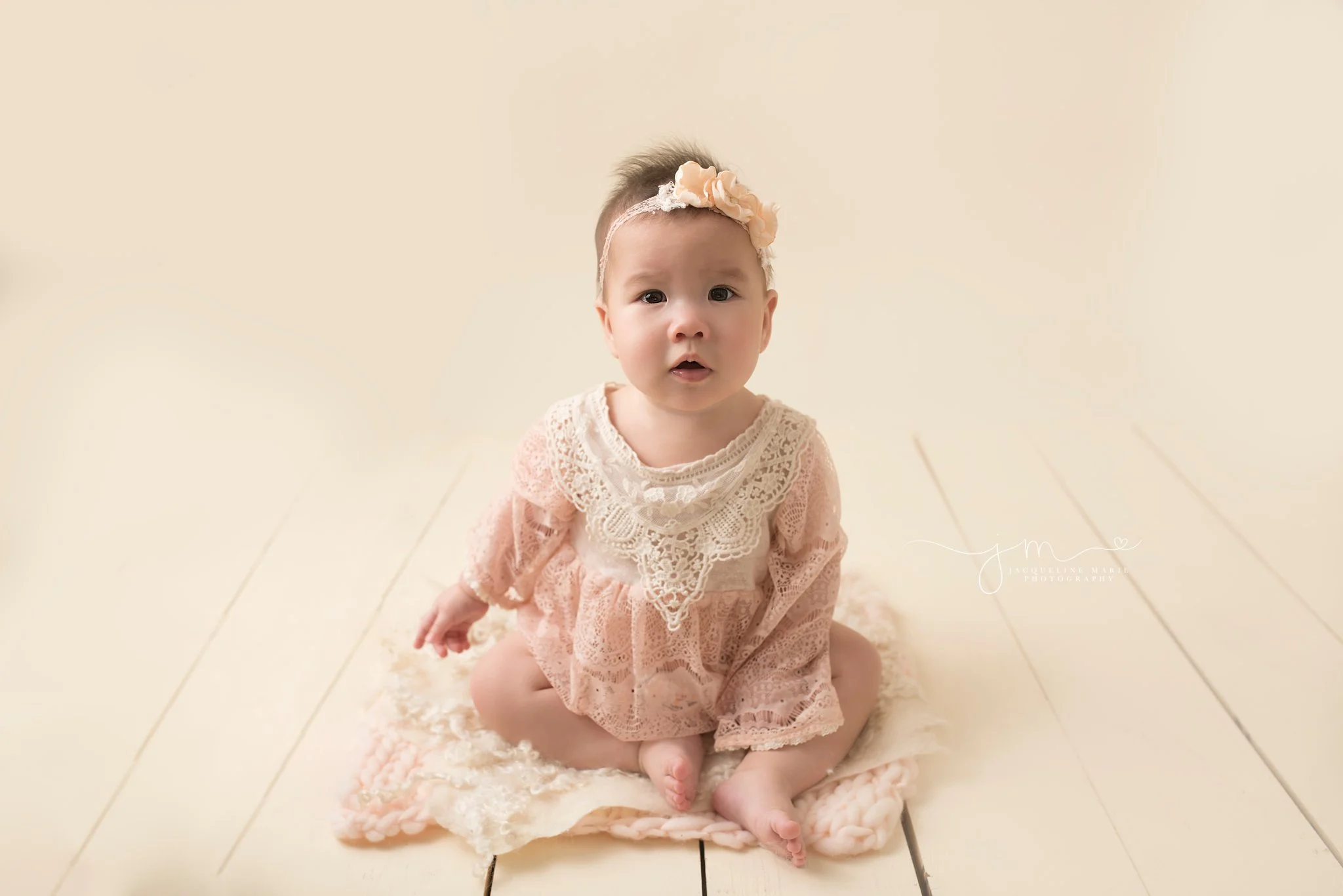 columbus ohio baby photographer features 6 month baby girl wearing lace romper and matching headband