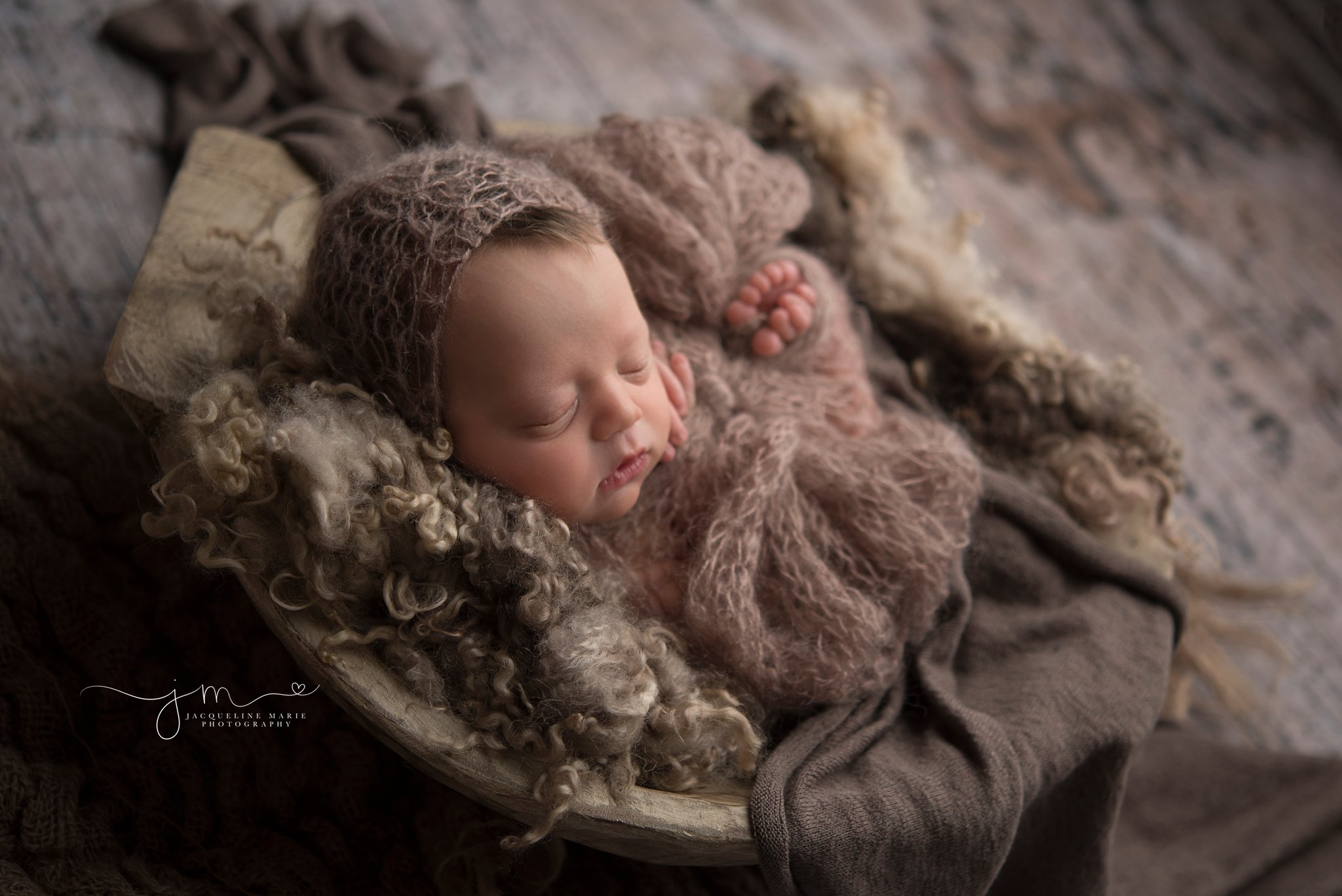 newborn baby girl wears brown bonnet for photography session by columbus ohio newborn photographer