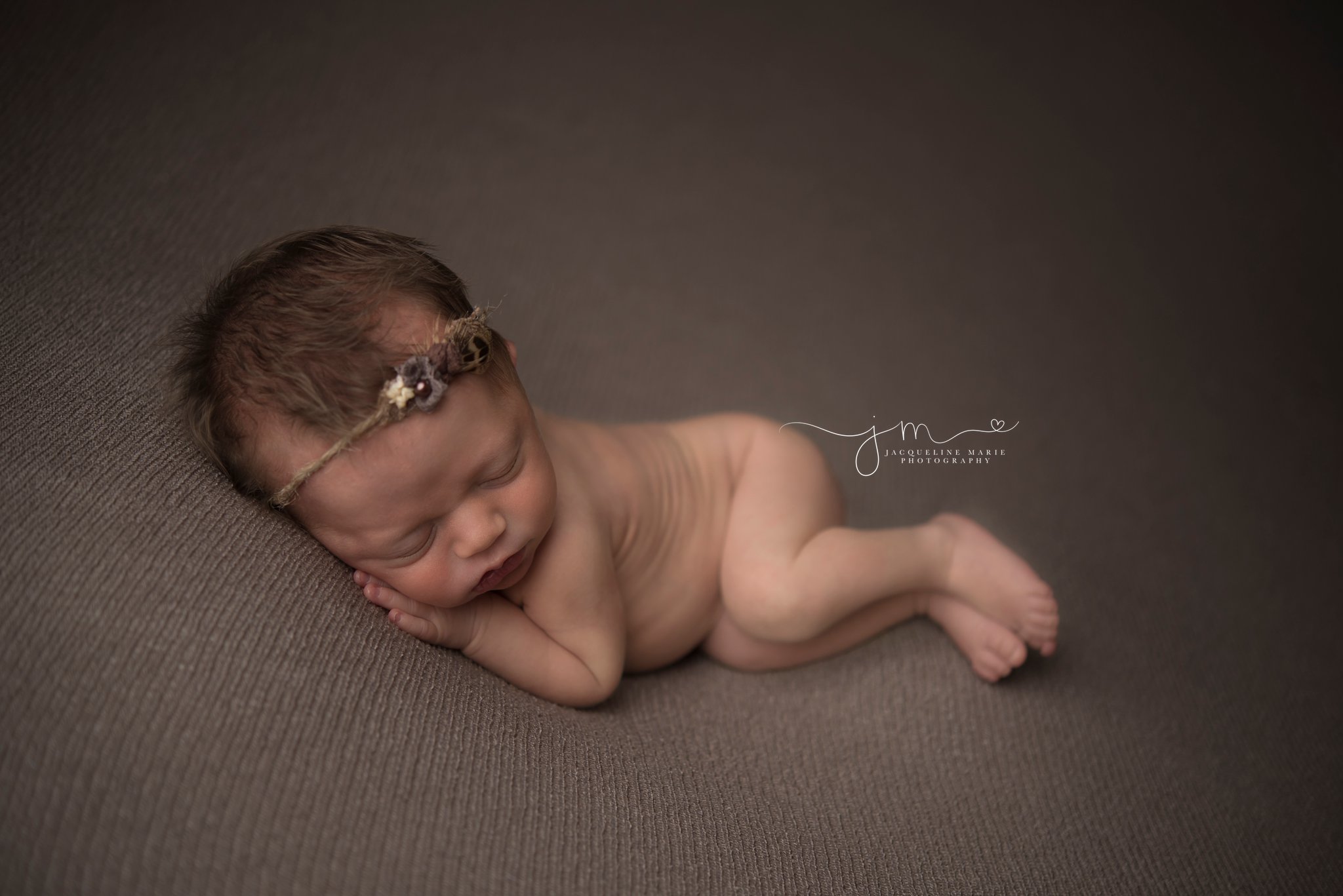 5 day old newborn baby girl wears tieback headband for portrait featuring sleeping baby by columbus ohio newborn photographer jacqueline marie photography