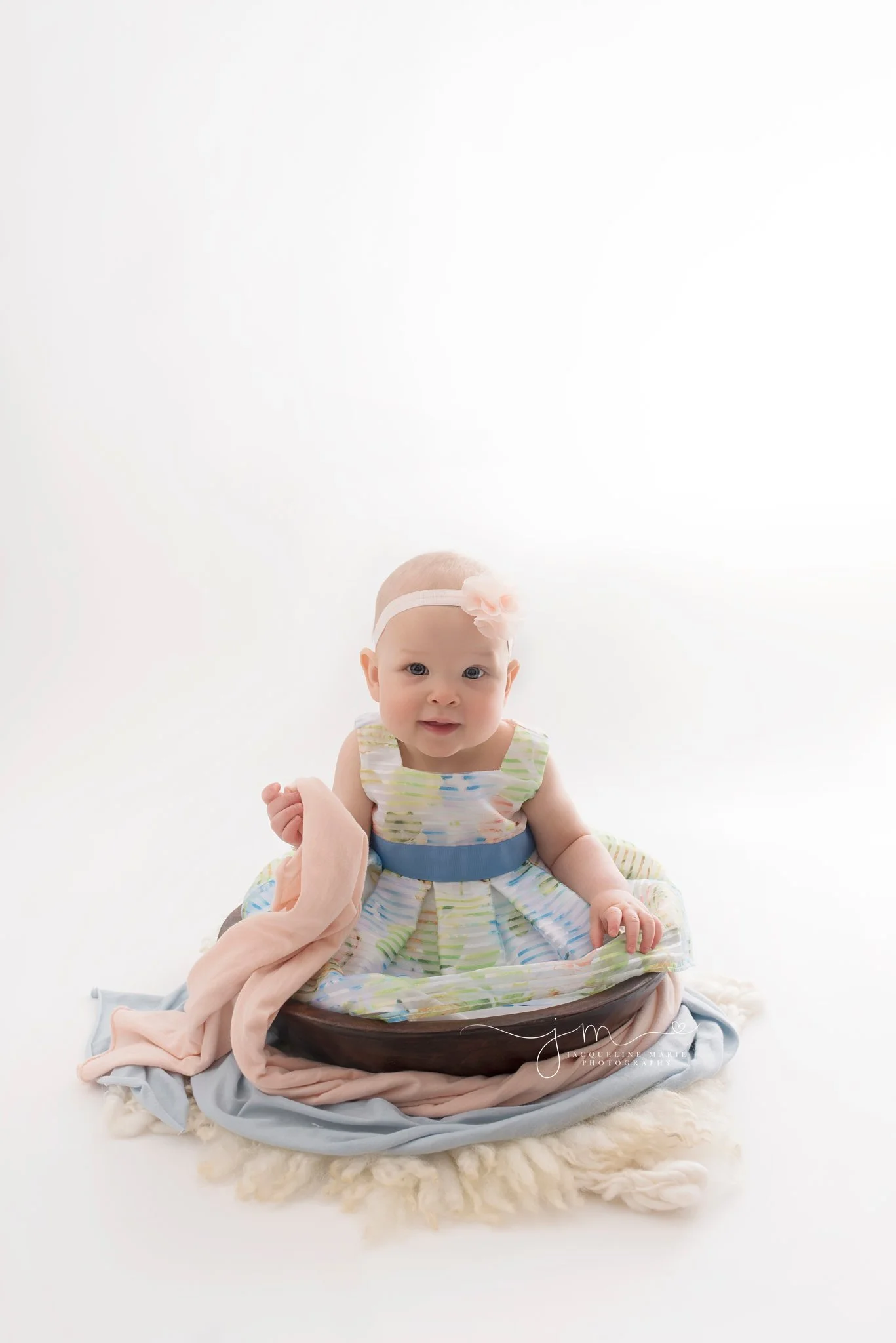 columbus ohio baby girl wears white and blue dress at jacqueline marie photography studio