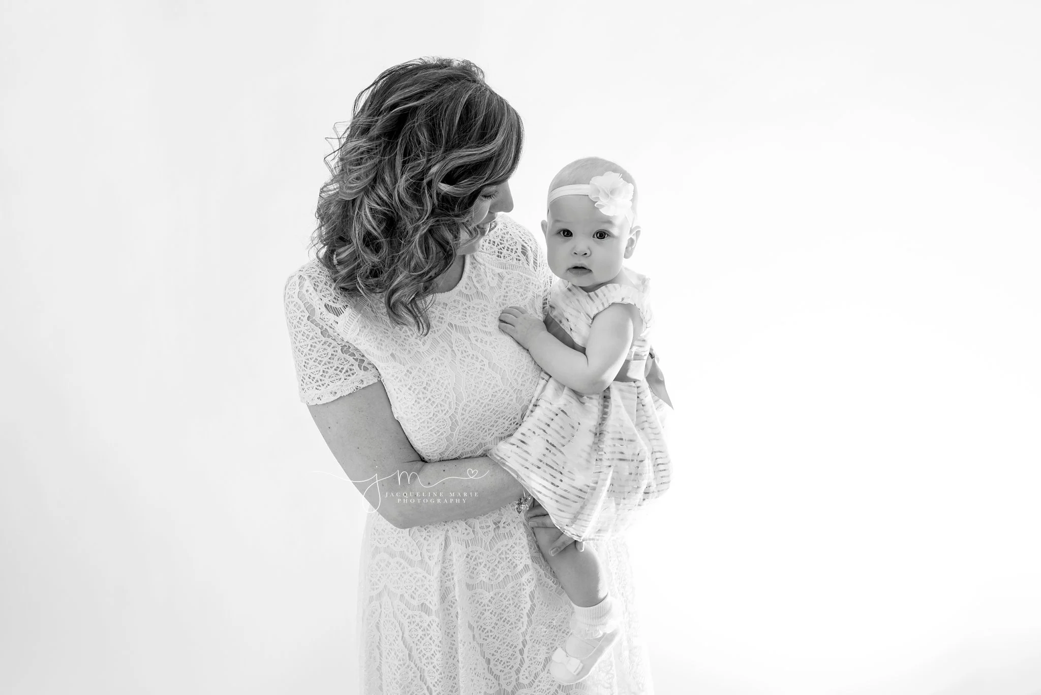 black and white image features mother holding daughter for baby photography in columbus ohio portrait studio