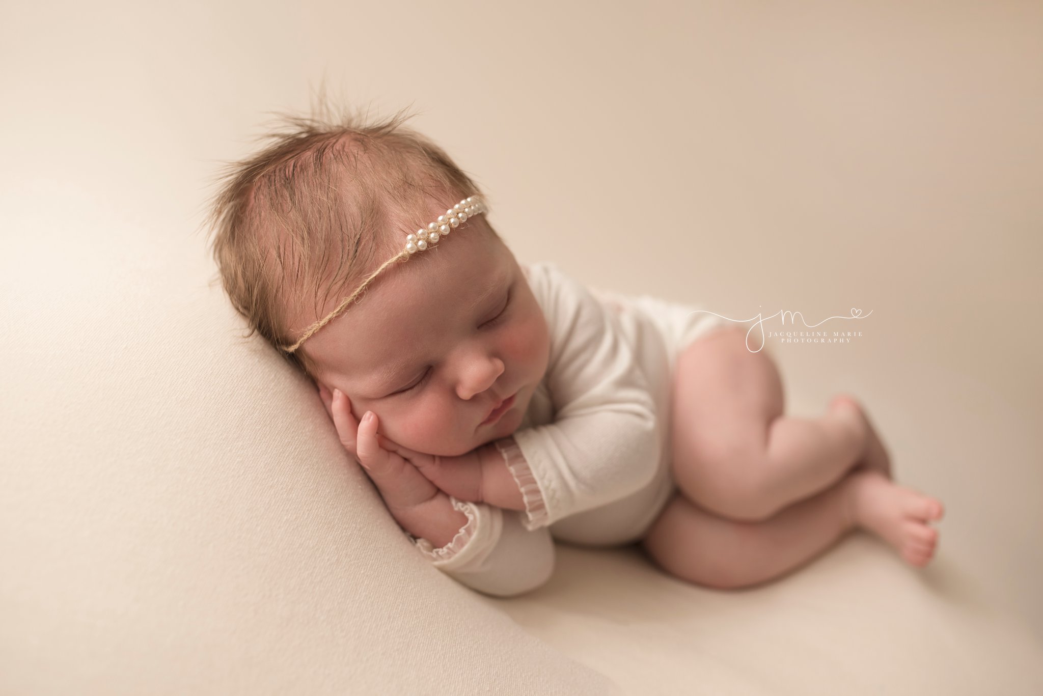 columbus ohio newborn photographer features baby girl wearing pearl headband while sleeping