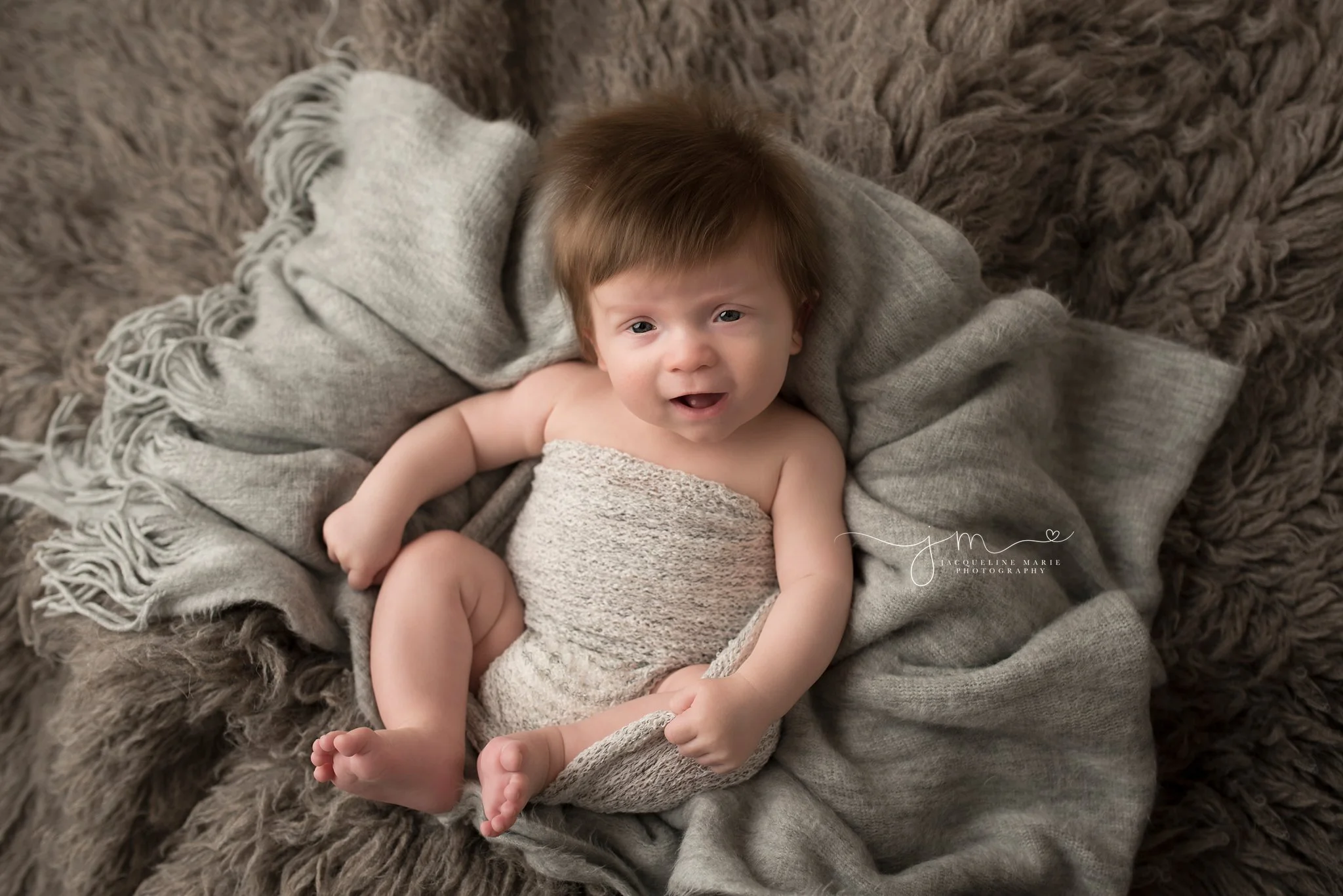 3 month old baby boy portrait features baby smiling with thick brown hair in columbus ohio