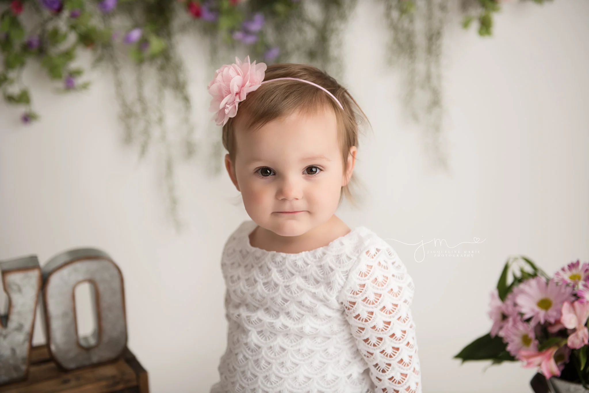 2 year old little girl wears pink floral headband for birthday milestone portraits in columbus ohio