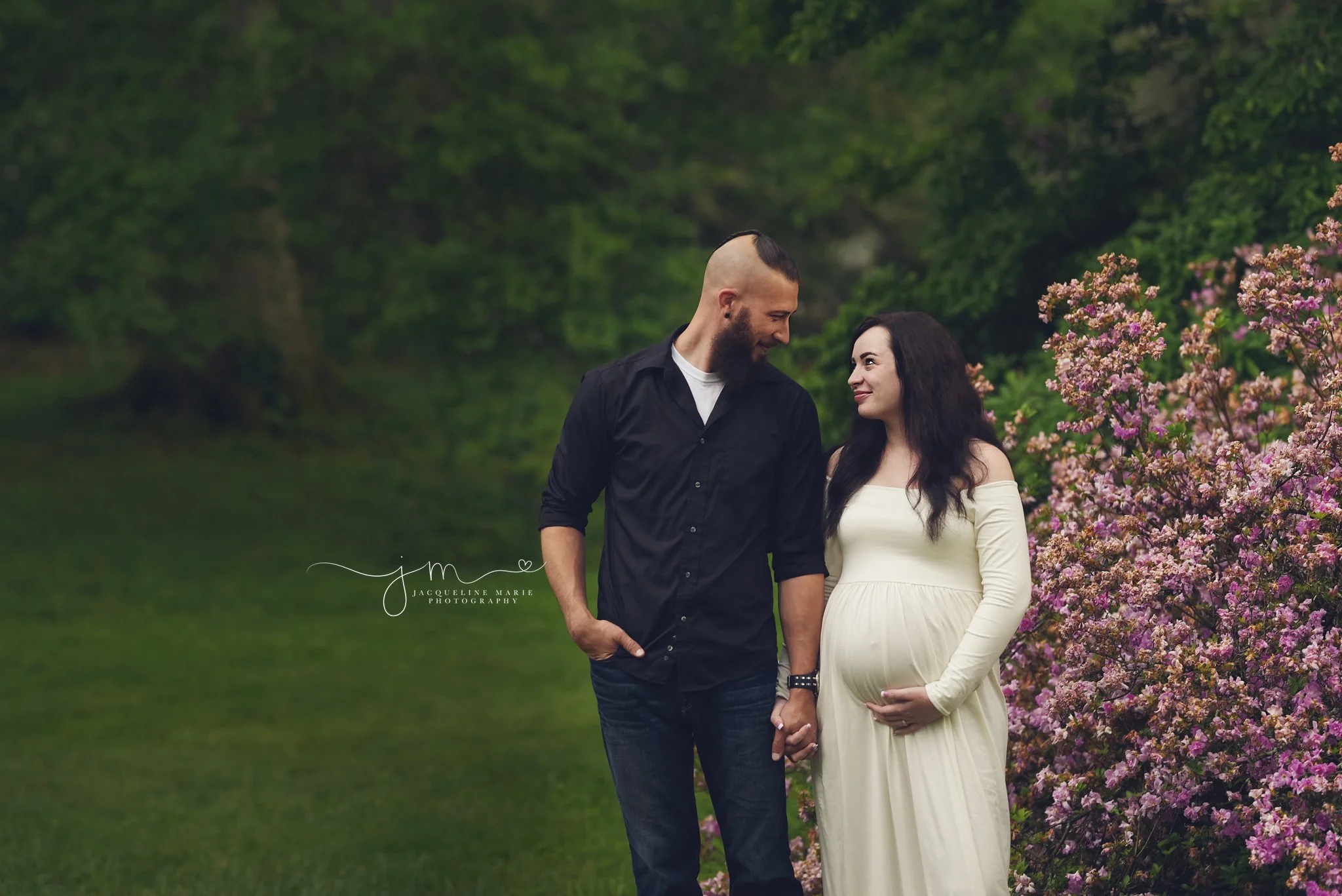 columbus ohio mother and father smile next to purple flowers for maternity photography portraits 