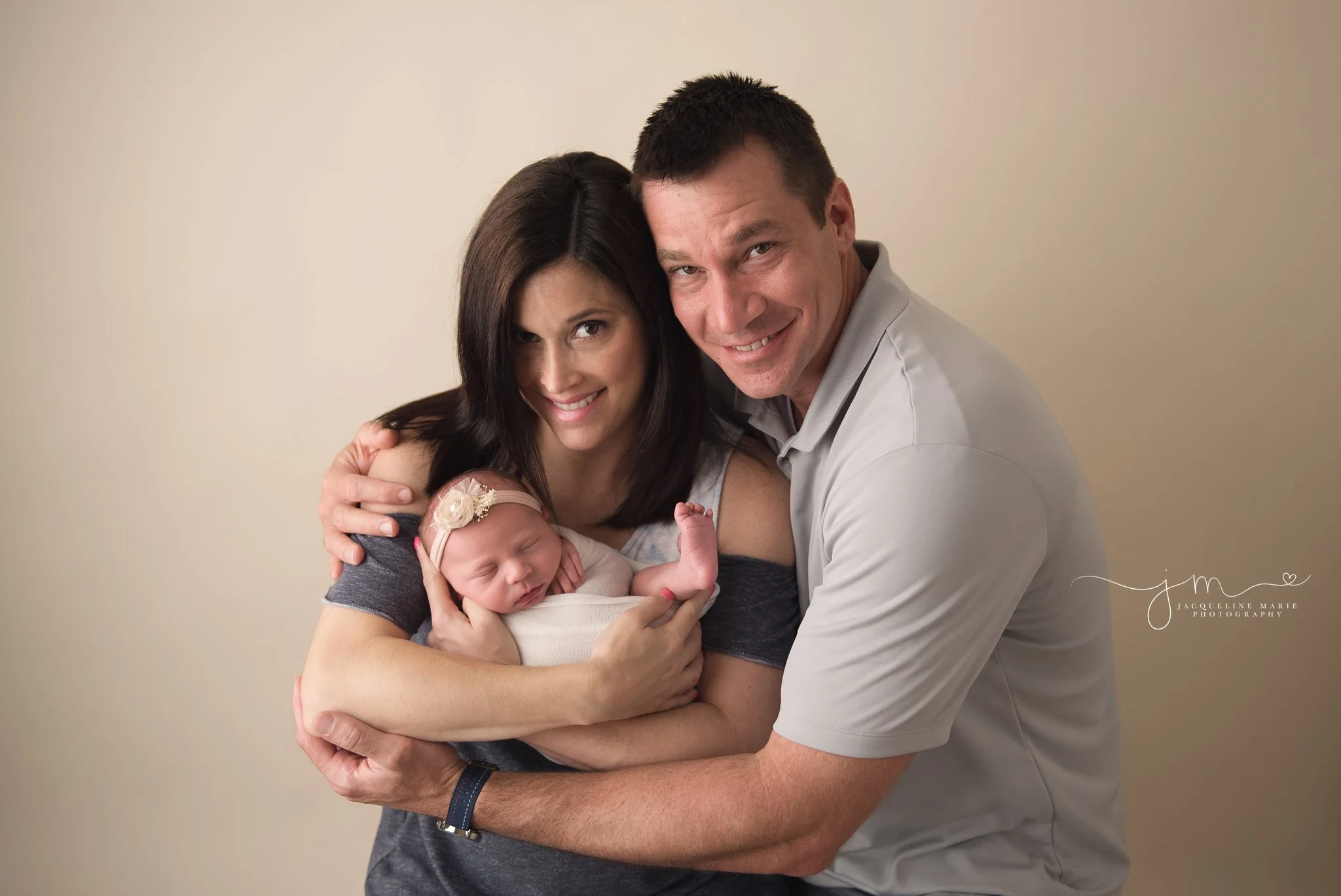 new parents hold newborn baby girl for newborn photography pictures in columbus ohio