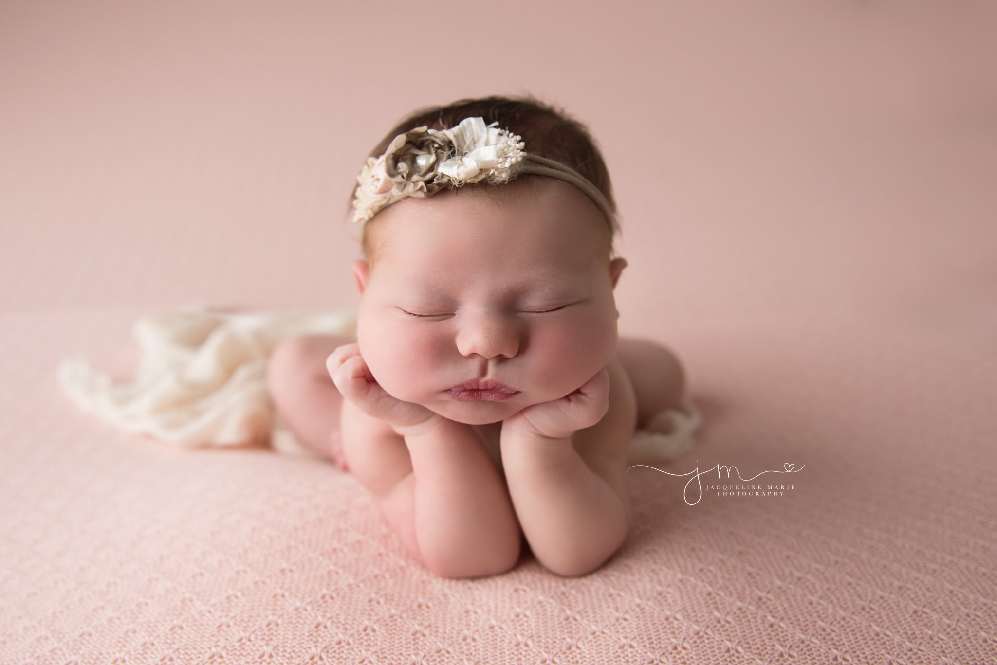 newborn photography portraits feature baby girl wearing pink and cream headband in Columbus ohio