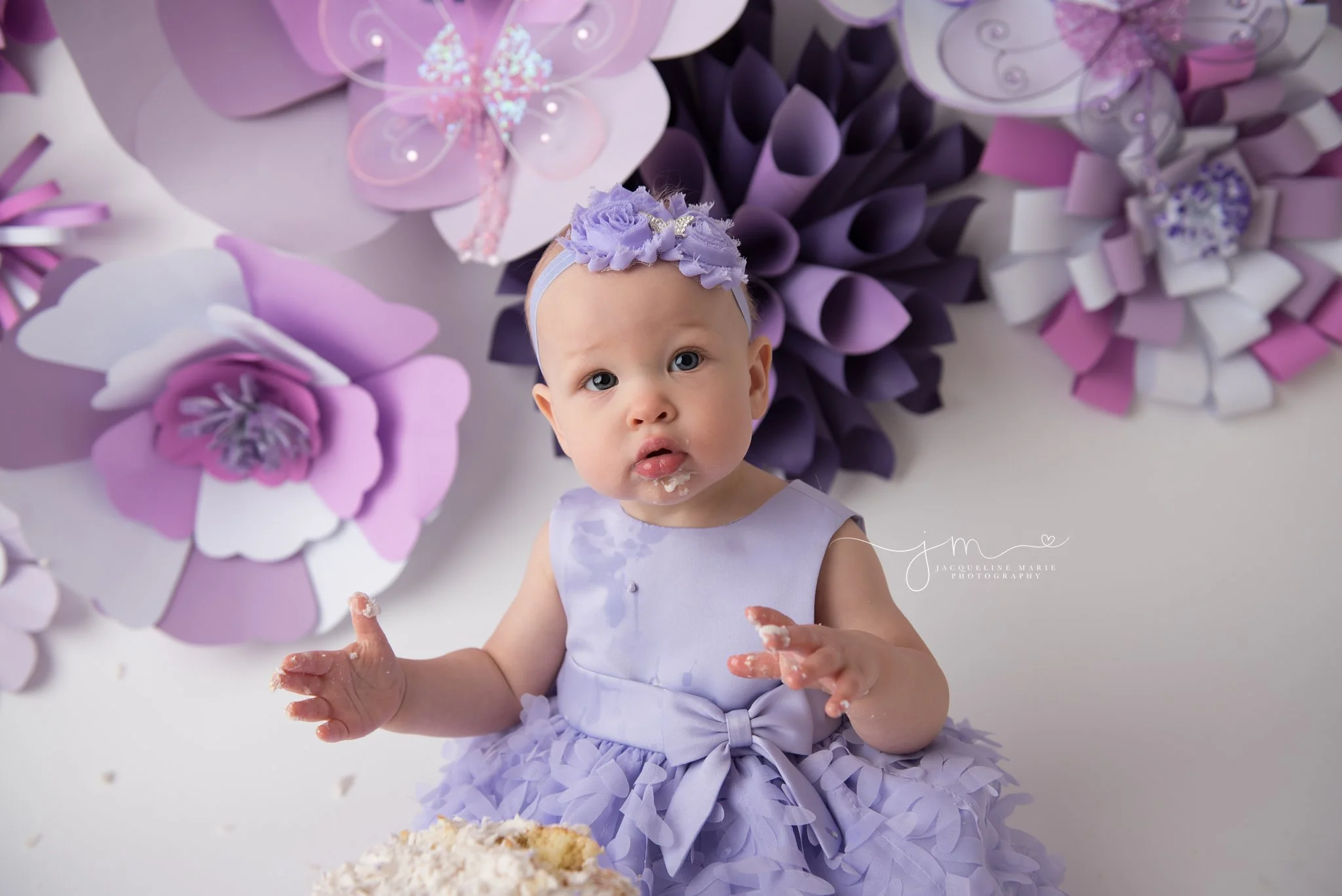 columbus ohio first birthday photographer features image of baby girl eating cake for first birthday pictures
