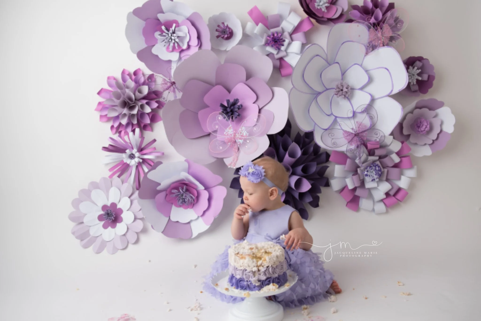 first birthday cake smash photography features purple flower cake in columbus ohio