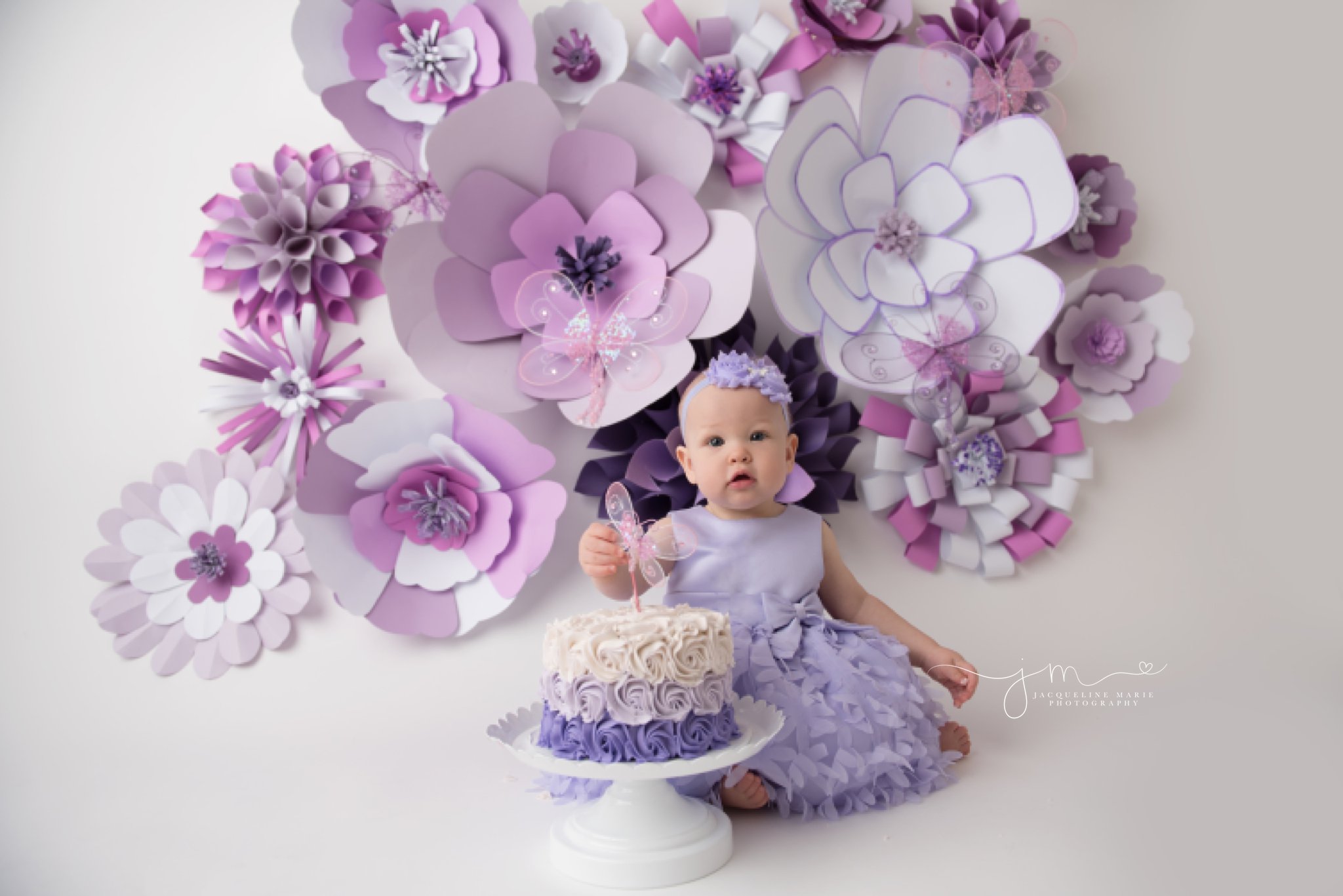 First Birthday Cake Smash Photographer Columbus Ohio | Children milestone photography | First Birthday cake smash photography featuring purple flowers | Happy Birthday Adalyn