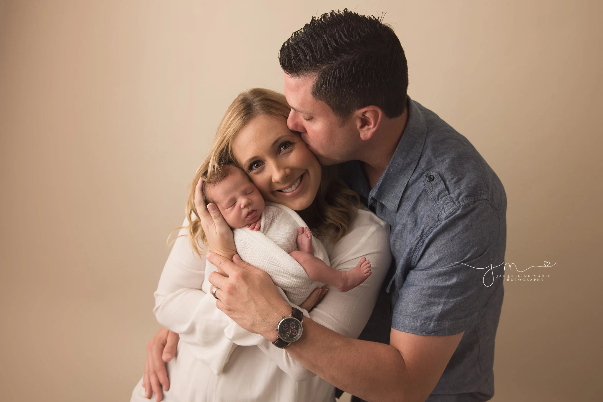 mother holds newborn baby boy while father kisses her in columbus ohio