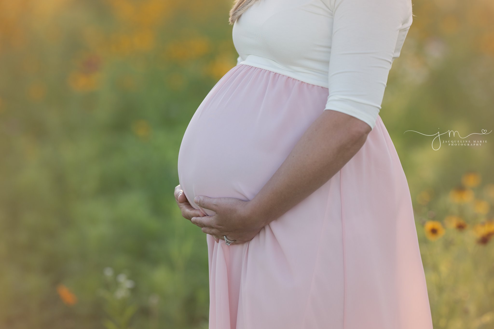 columbus ohio mother to be places her hands on her belly to show her baby bump for pregnancy and maternity photographer pictures
