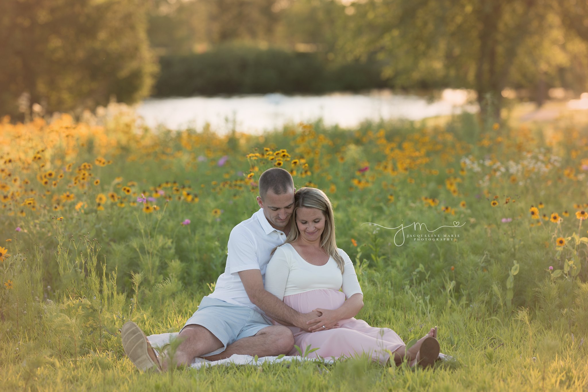 columbus ohio newborn photographer features pregnancy picture of soon to be mother and father smiling at sunset