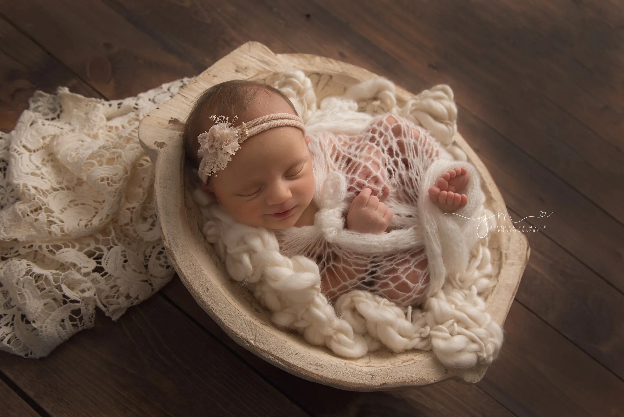 7 day old newborn baby is wrapped in vintage lace for newborn photography pictures in columbus ohio