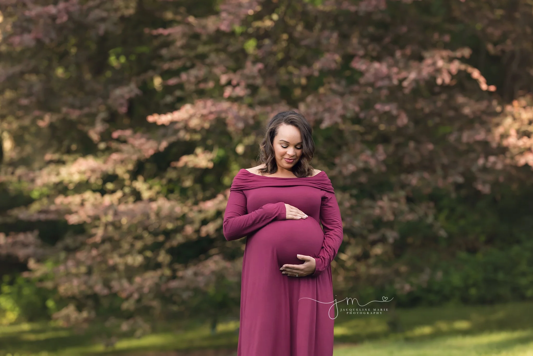 columbus ohio pregnancy and maternity photographer features mother holding belly at a park wearing a dress
