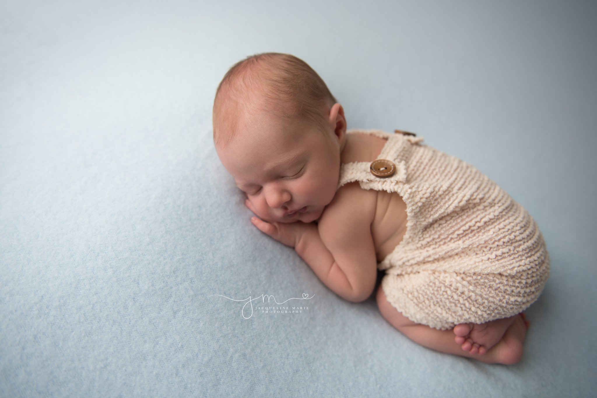 columbus ohio newborn photographer features images of baby boy wearing cream romper 