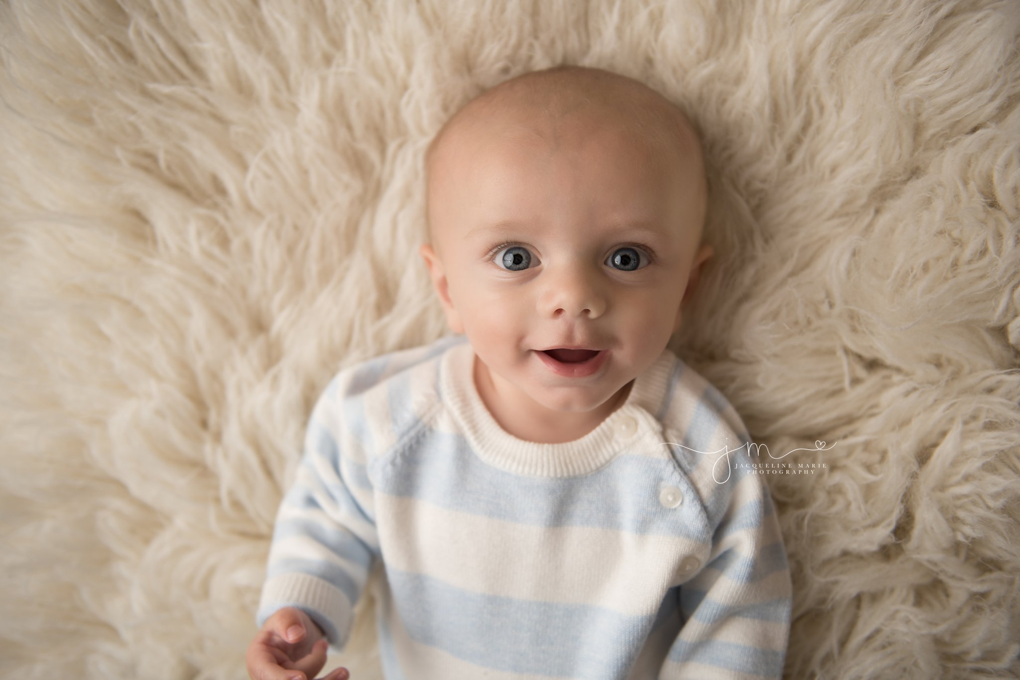 columbus ohio baby photographer features baby boy wearing blue and cream striped outfit