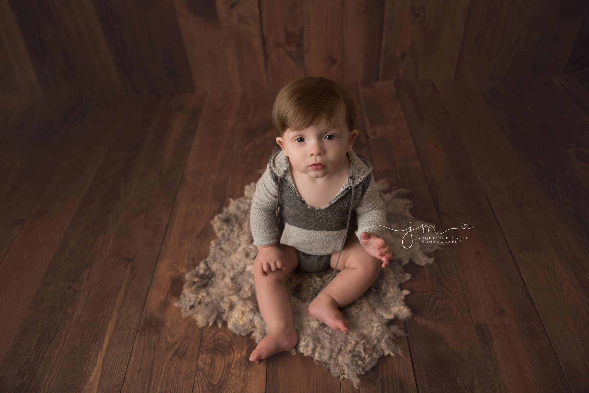 columbus ohio baby photographer features baby boy wearing gray hooded romper for photography session