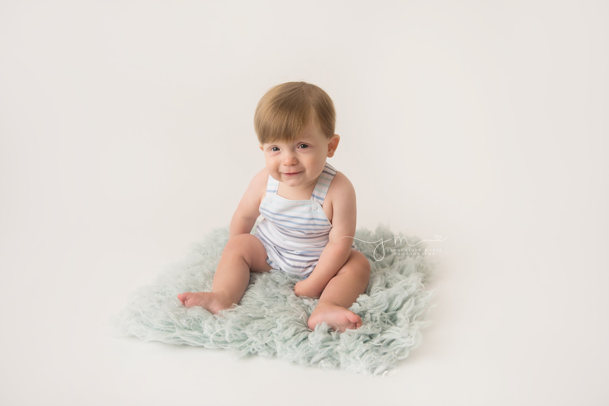 columbus ohio baby boy wears striped romper for milestone photography pictures 