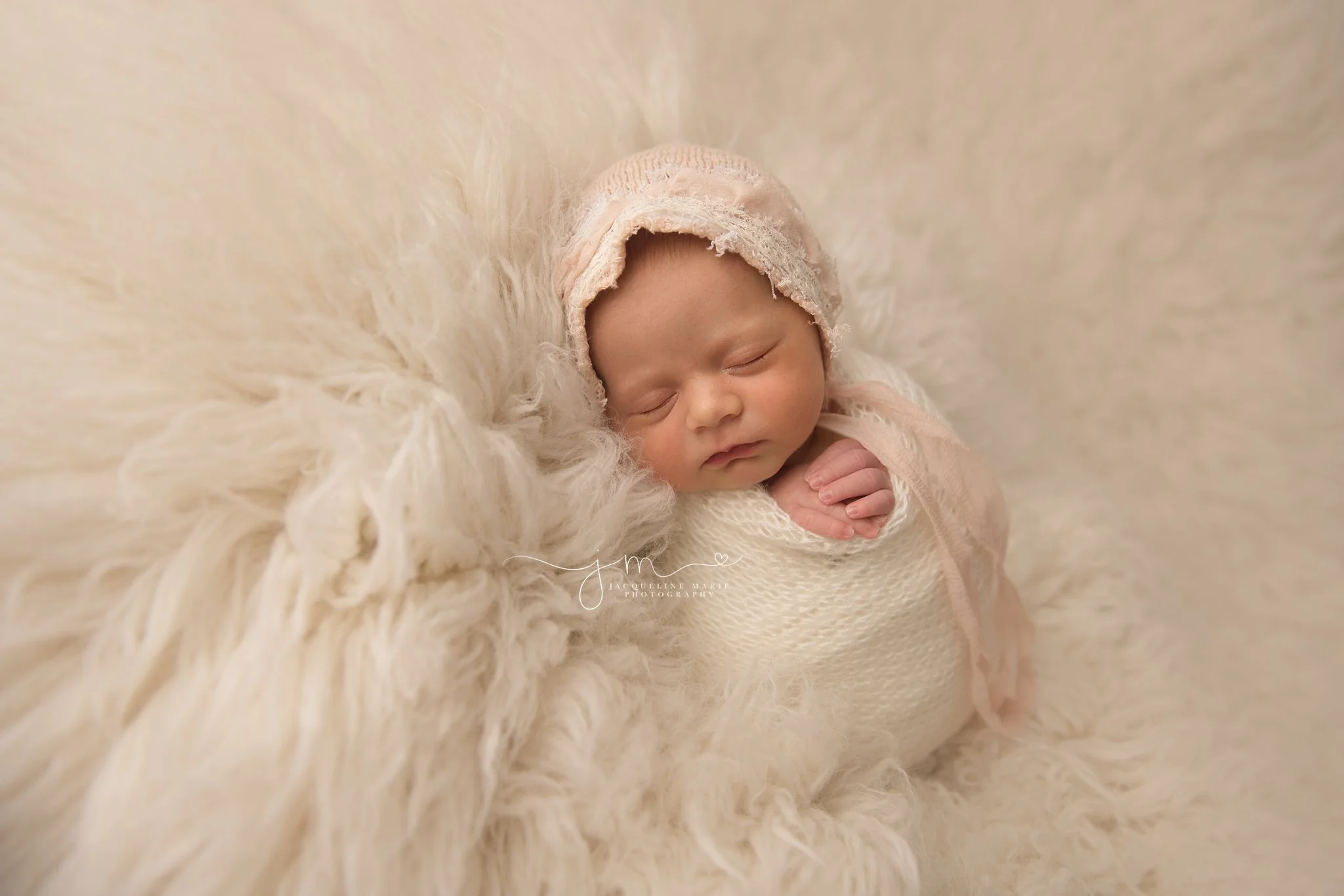 columbus ohio newborn photographer features image of newborn baby girl in pink bonnet