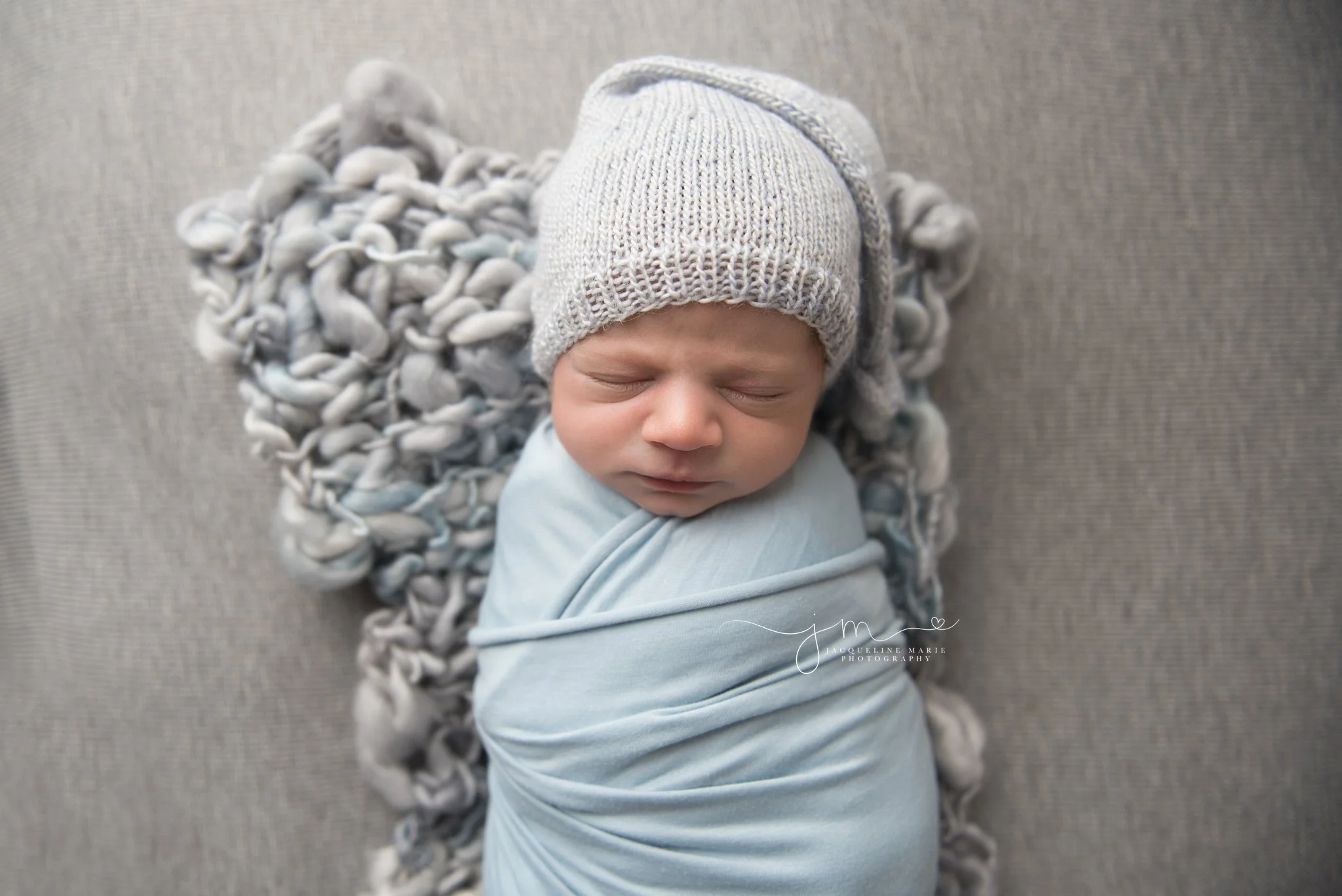 columbus ohio newborn photographer swaddled baby in blue wrap with matching hat for newborn pictures