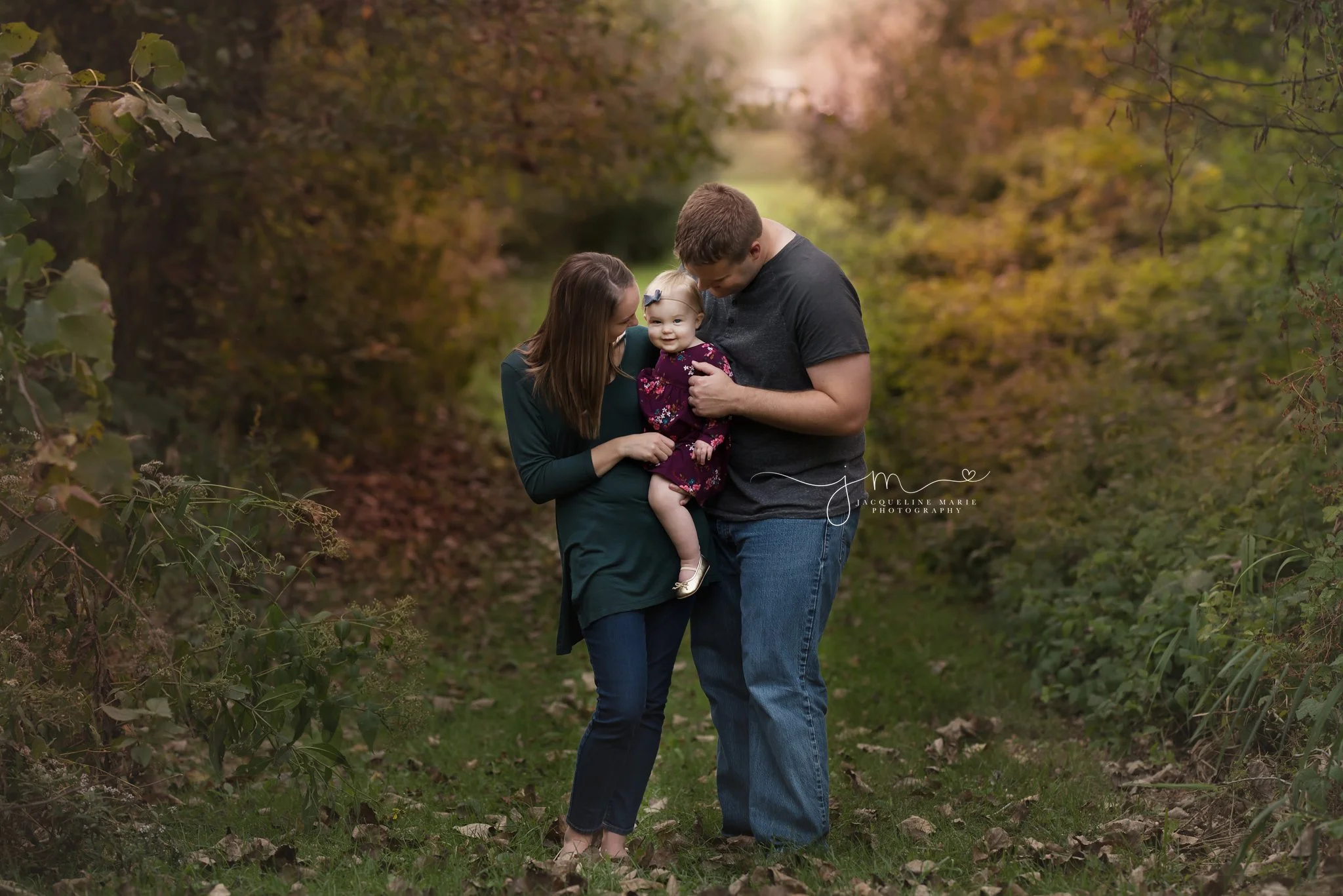 mother and father hold daughter while smiling in columbus ohio