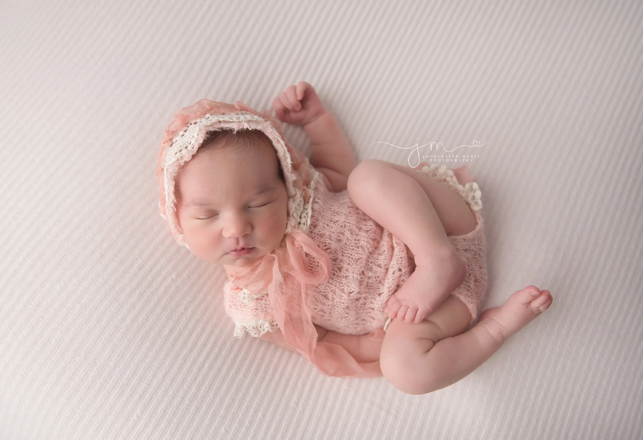 columbus ohio newborn photographer features images of baby girl wearing pink and cream lace bonnet while sleeping 