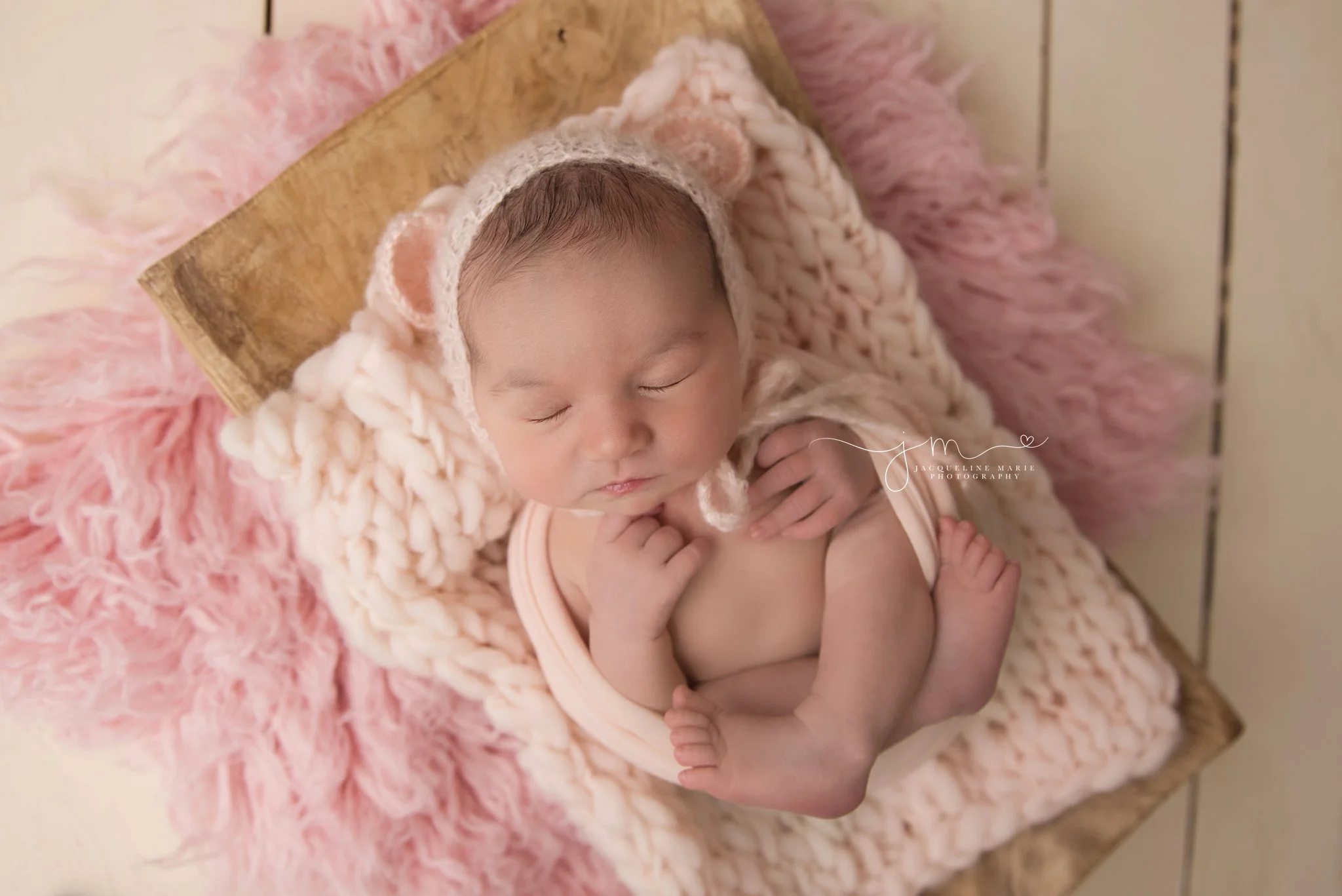 columbus ohio newborn baby girl wears pink teddy bear bonnet for newborn photography pictures