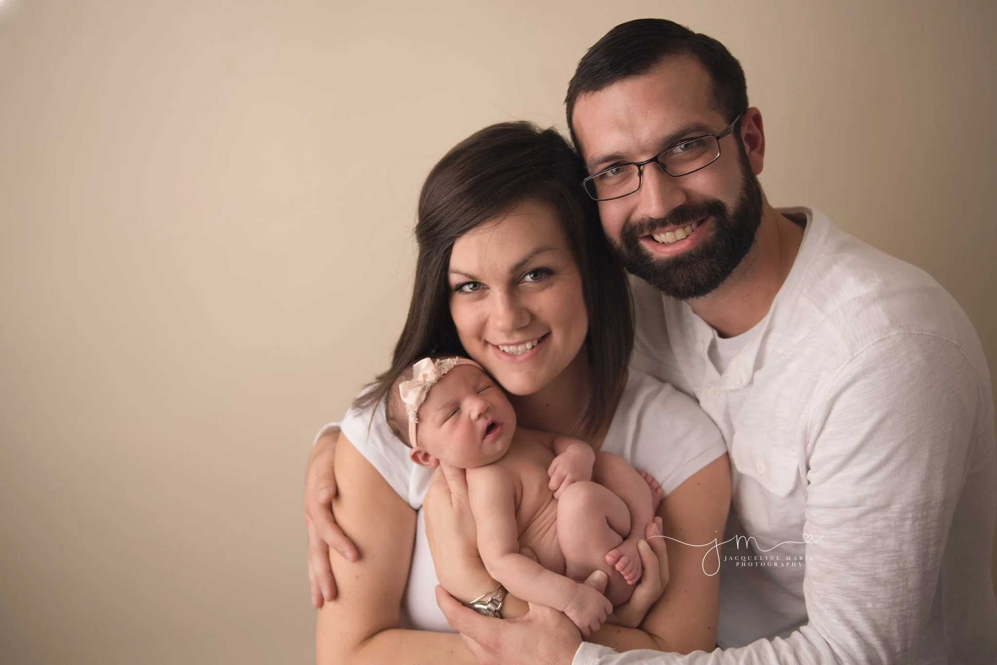 prop new parents hold newborn baby girl for studio newborn photography in columbus ohio